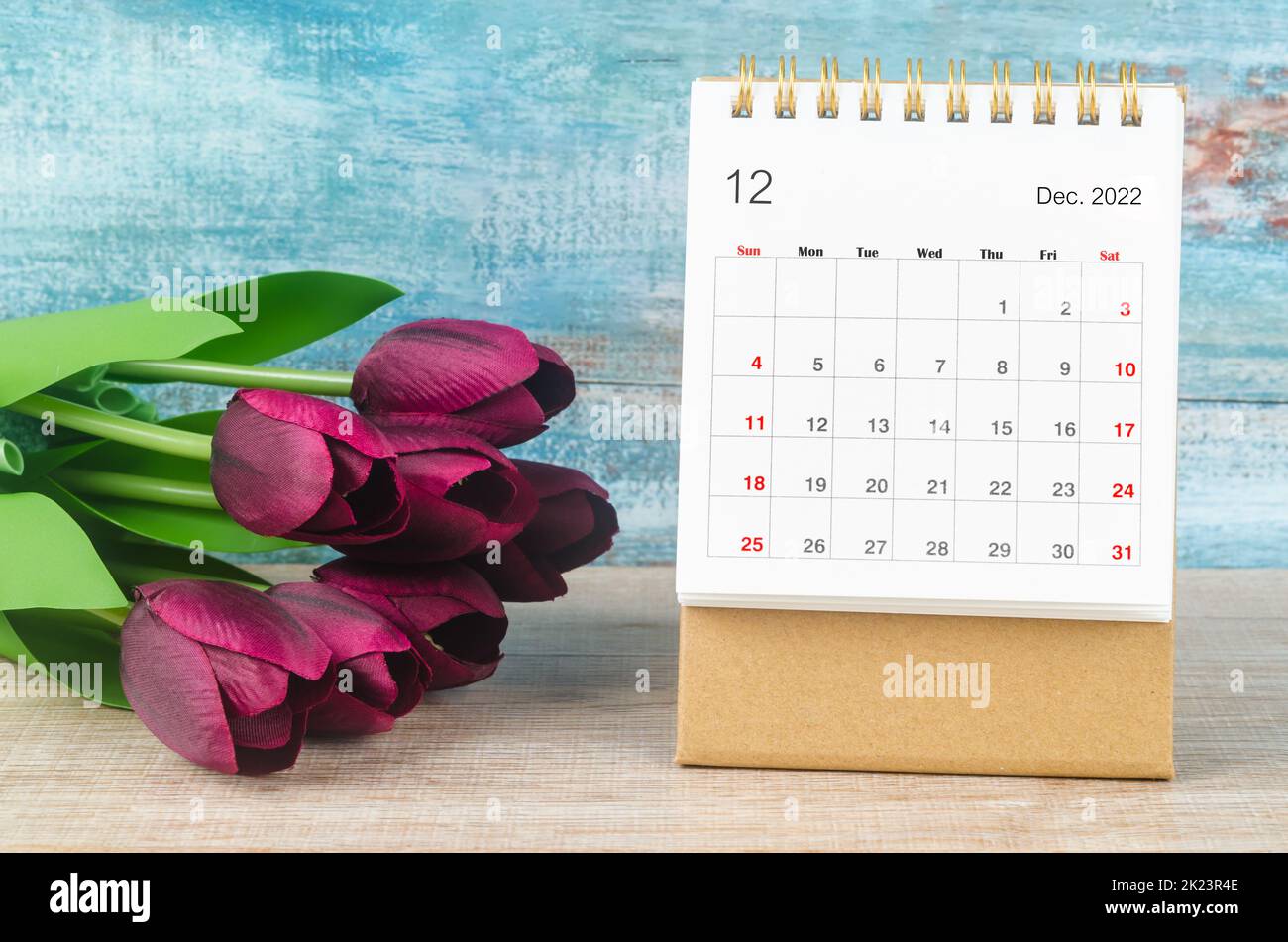 December 2022 Desk calendar for 2022 year with flower on wooden background. Stock Photo