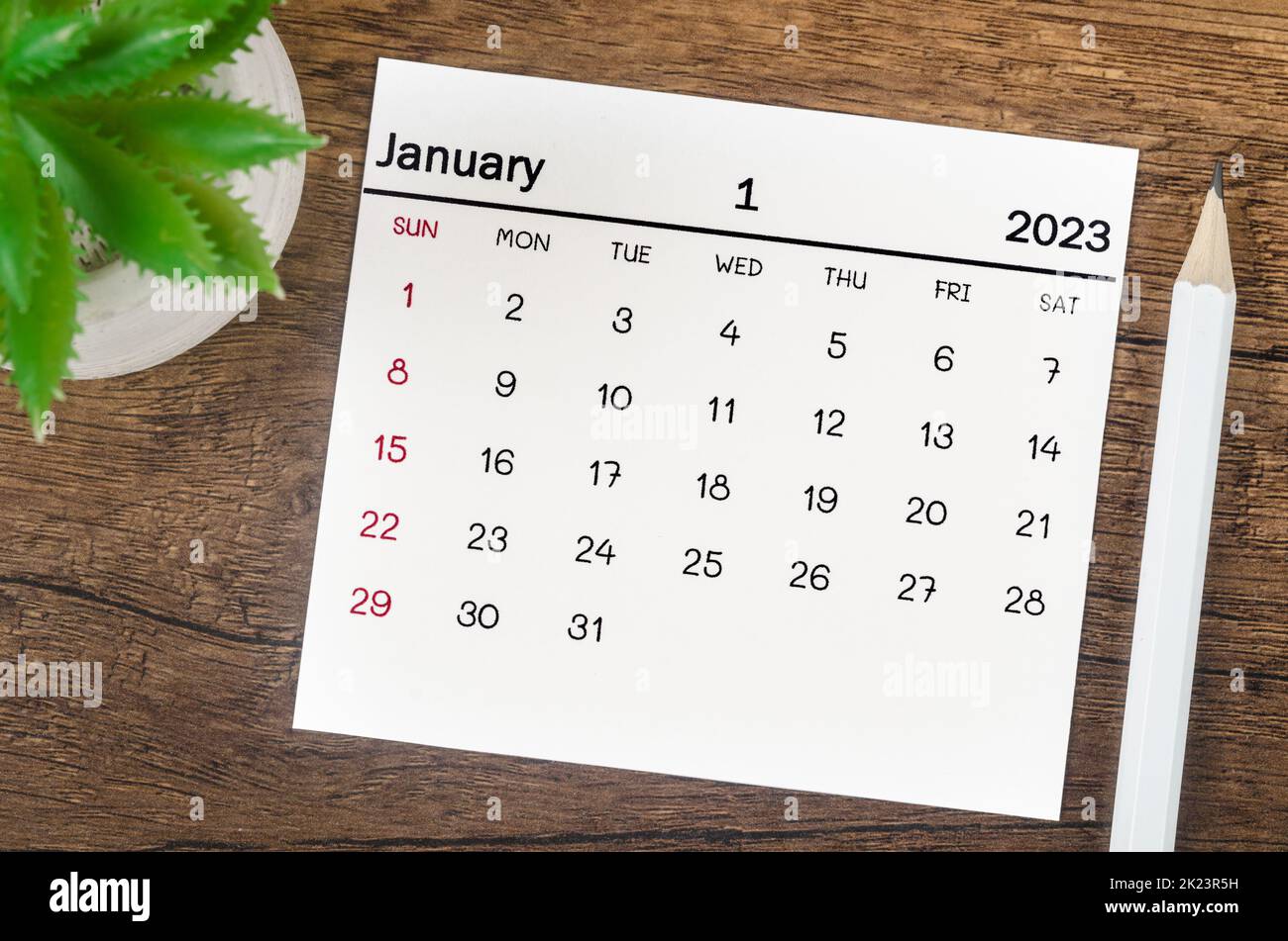 January 2023 Monthly calendar for 2023 year with pencil on wooden table. Stock Photo