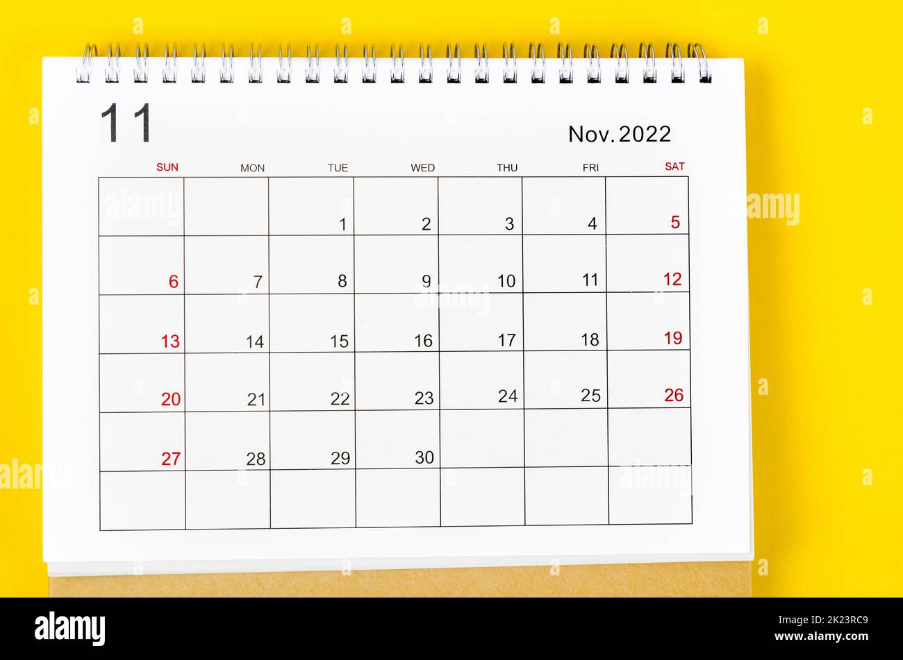 November 2022 Monthly desk calendar for 2022 year on yellow background. Stock Photo