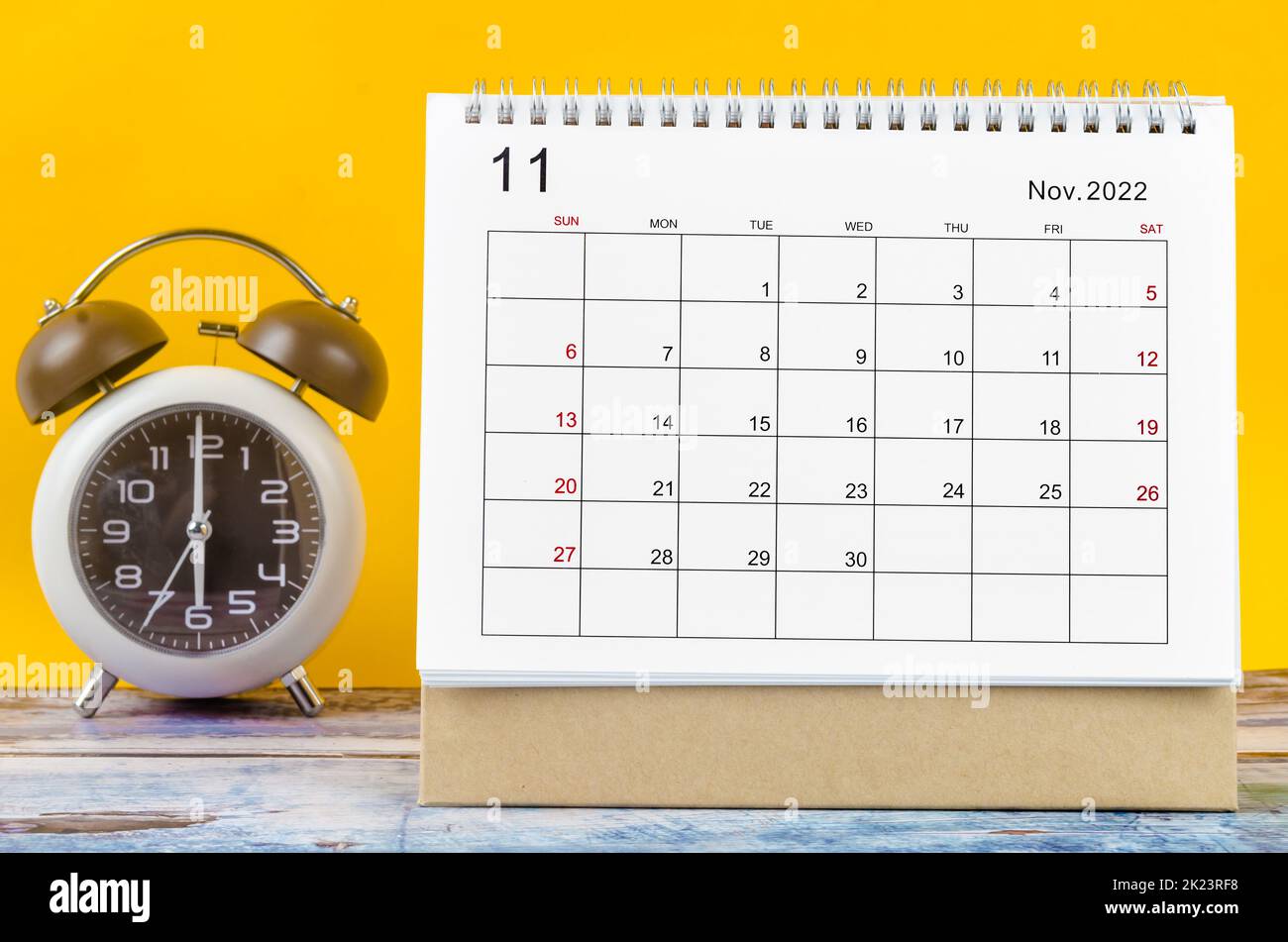 November 2022 Monthly desk calendar for 2022 year and alarm clock. Stock Photo