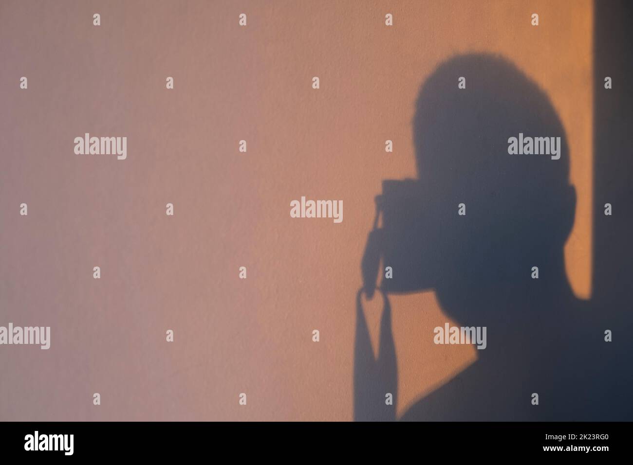 Shadows cast by photographer on wall Stock Photo - Alamy