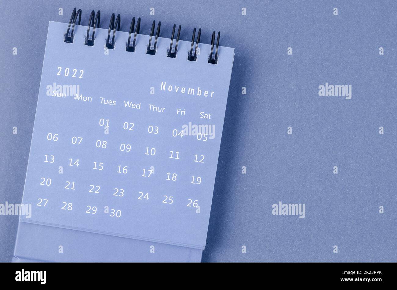 November 2022 Monthly desk calendar for 2022 year on blue background. Stock Photo