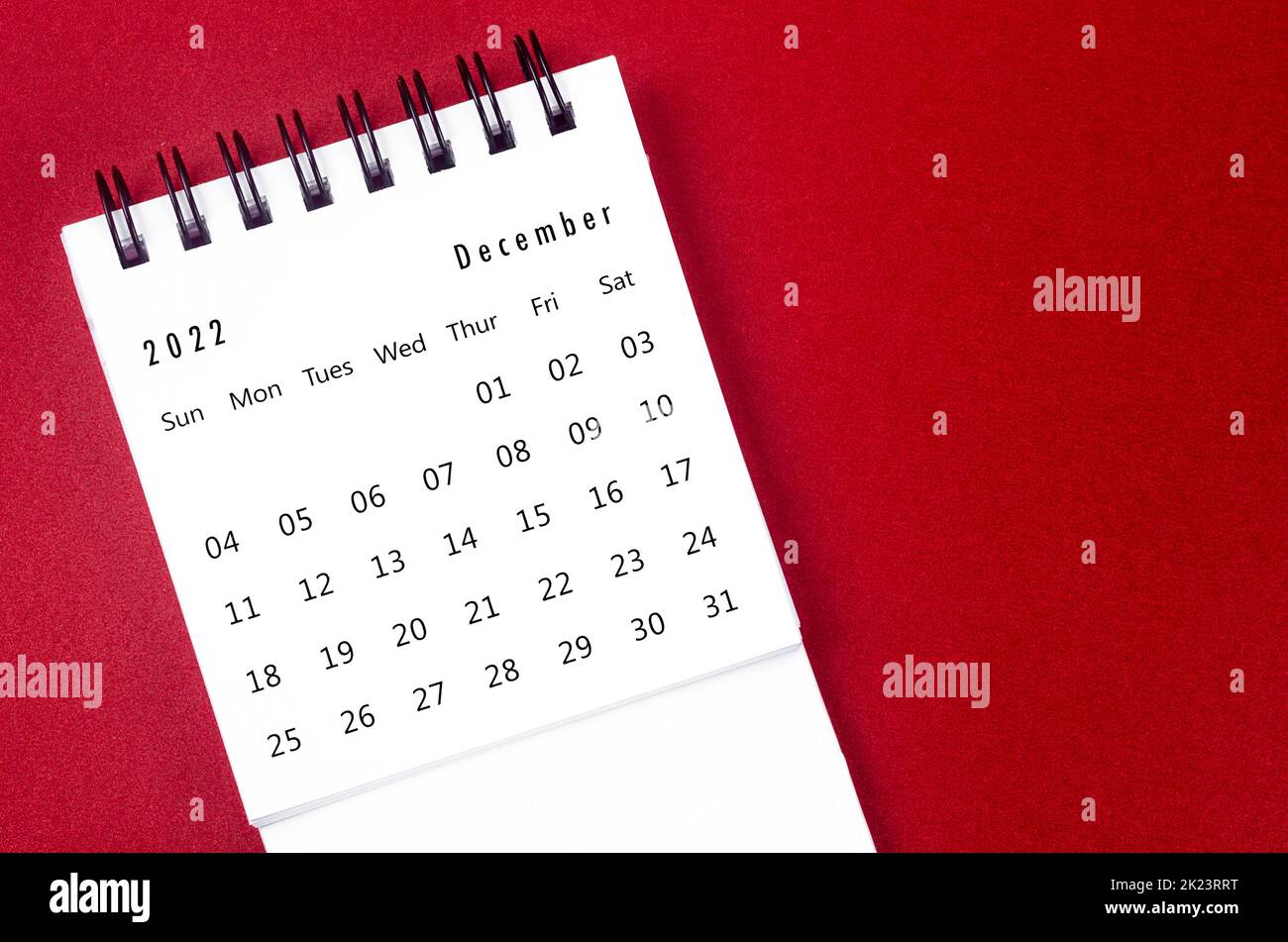 December 2022 Monthly desk calendar for 2022 year on red background. Stock Photo