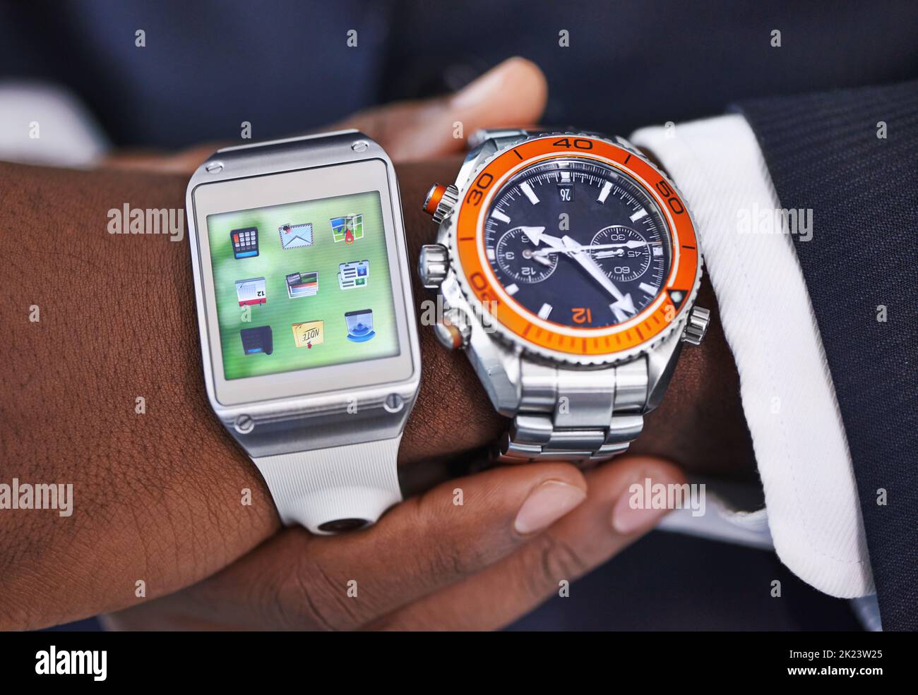 Old versus new. Cropped view of a young businessman wearing a smartwatch and a traditional watch