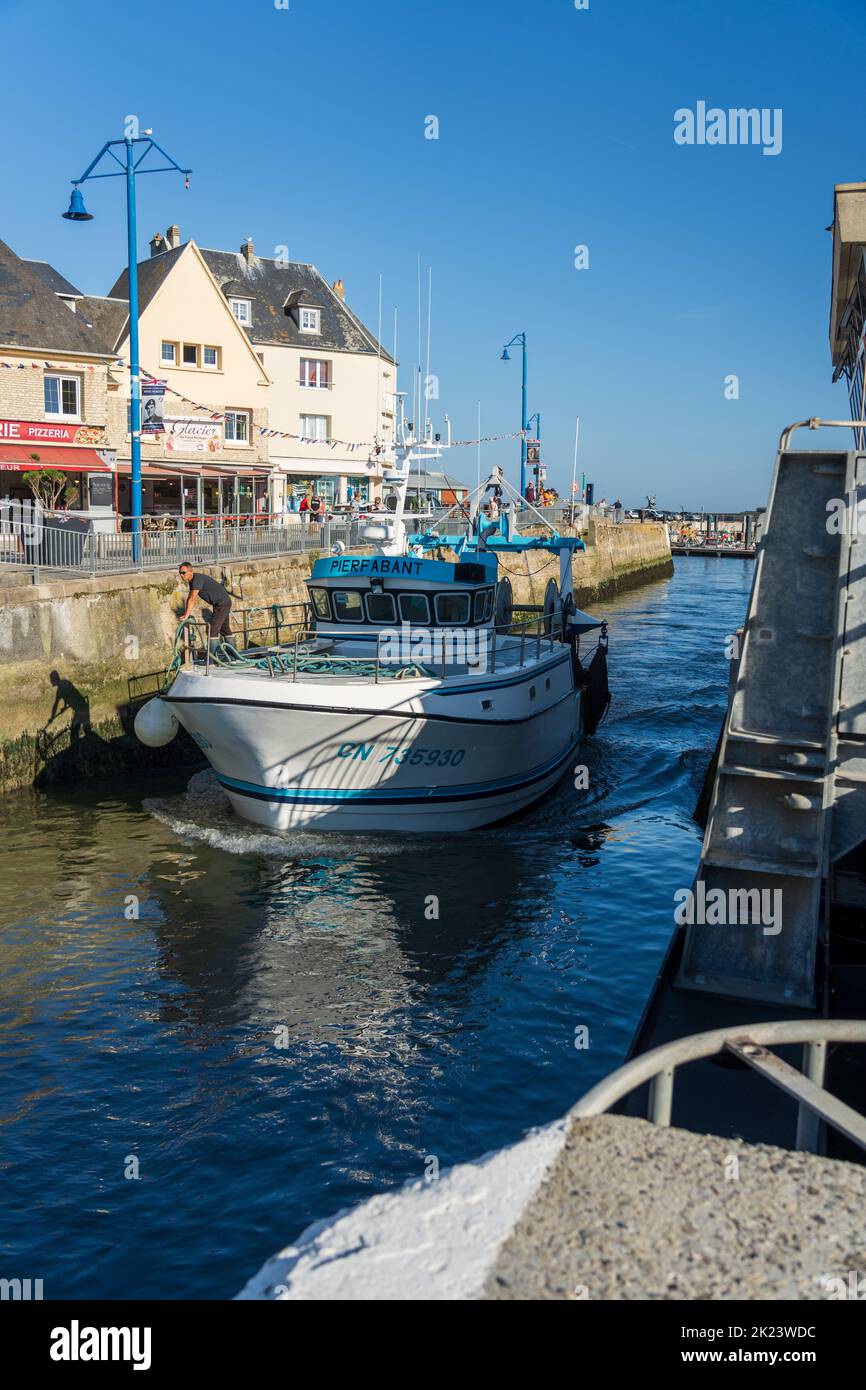 A sea fishing trawler returning to port at Port-en-Bessin, Normandy Stock Photo
