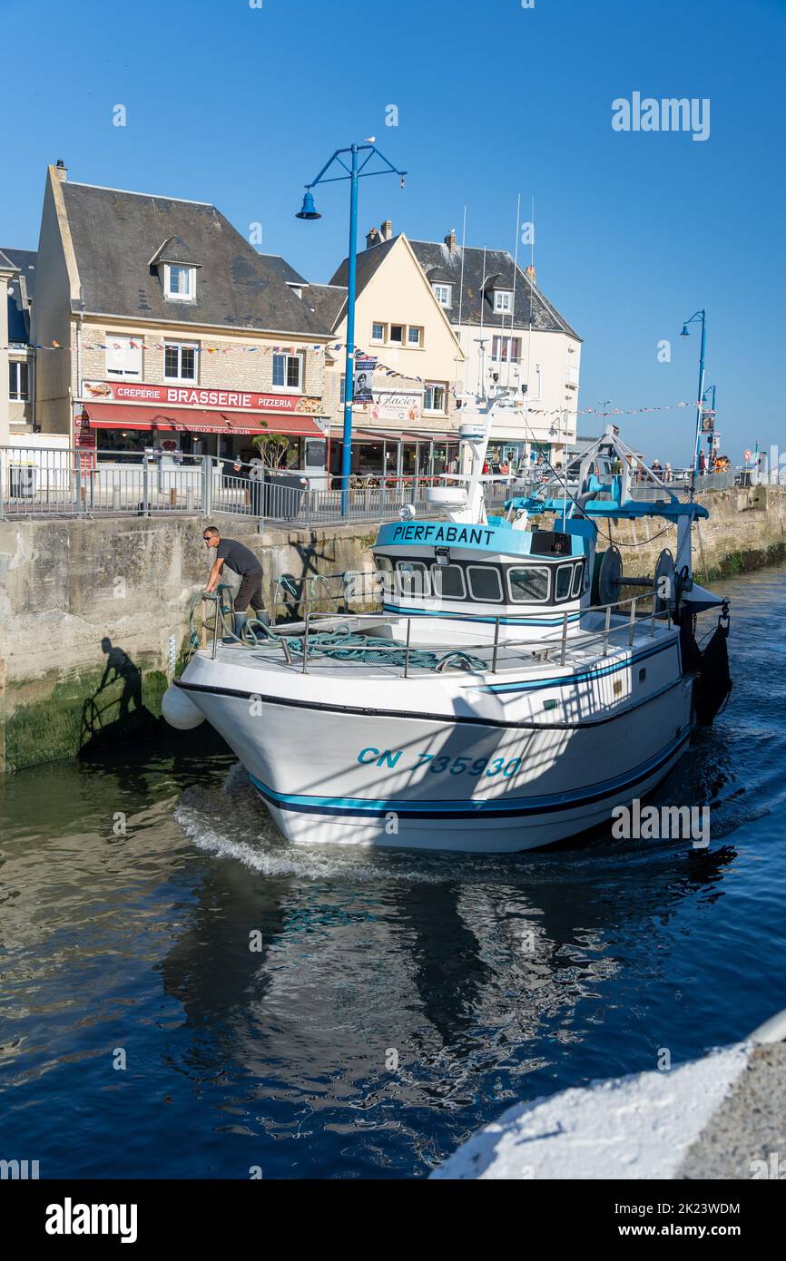 A sea fishing trawler returning to port at Port-en-Bessin, Normandy Stock Photo