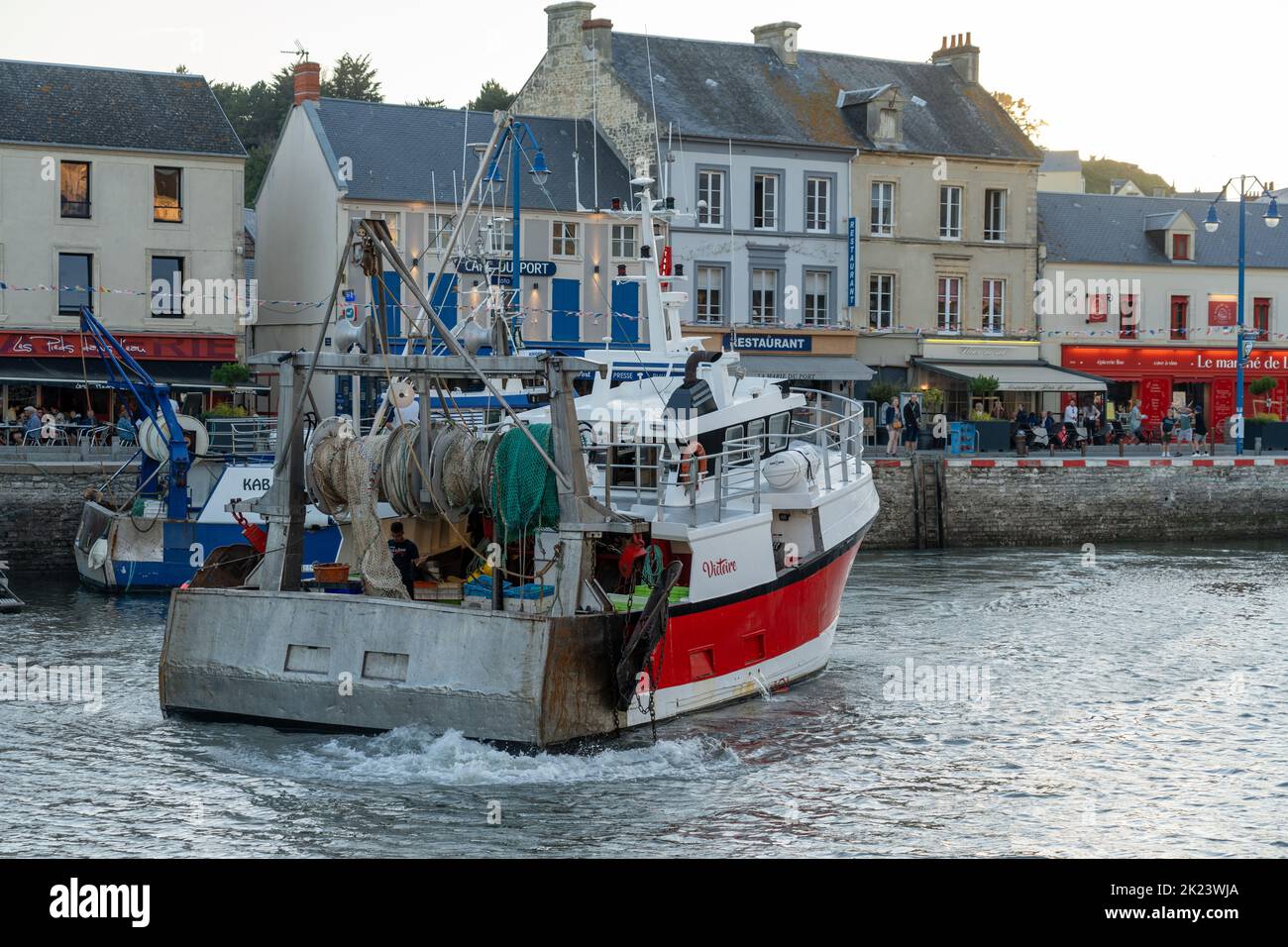 Sea fishing trawler leaving the docks at Port-en-Bessin Stock Photo