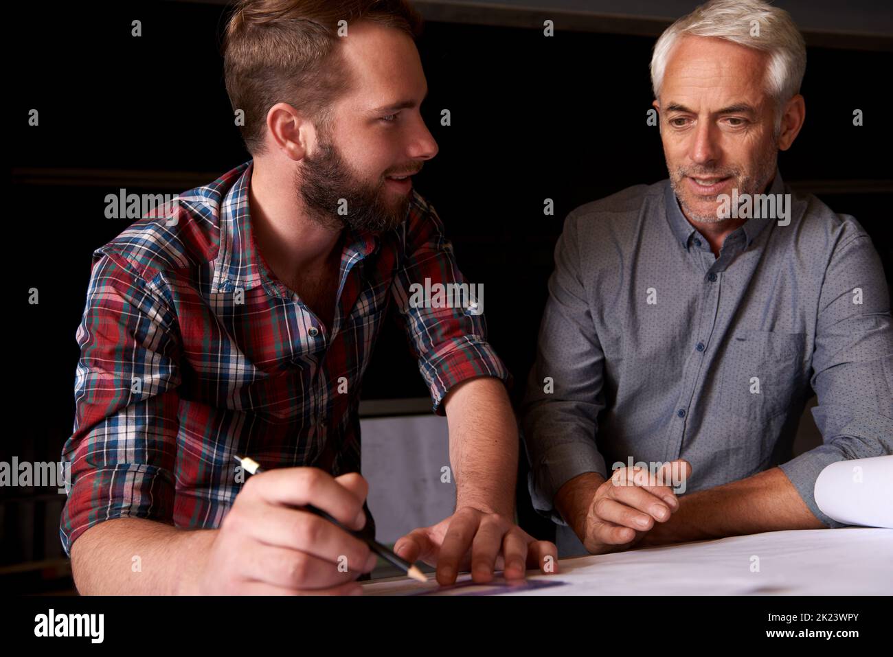 He had the best mentor. two architects working together on a building project. Stock Photo