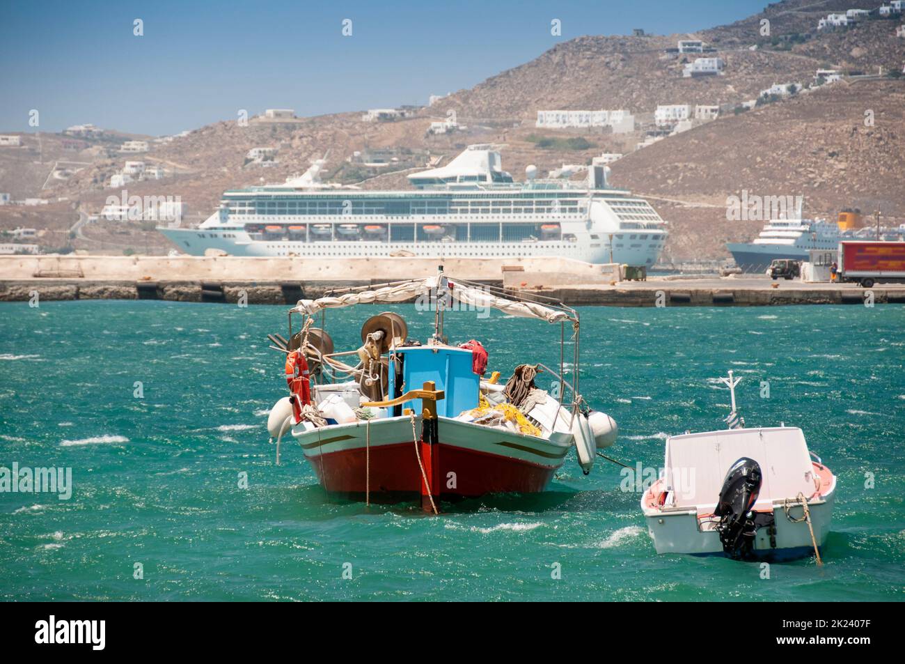 The traditional Greek fishing boat anchored in the harbor of Mykonos island in Greece Stock Photo