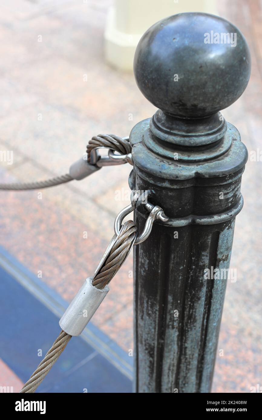 pole with metal restraining rope. Barrier, enclosed VIP area, protected  entrance, private event, restrict area barricade pole Stock Photo - Alamy