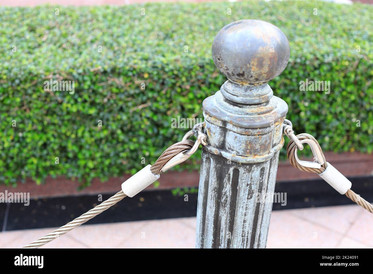 pole with metal restraining rope. Barrier, enclosed VIP area, protected entrance, private event, restrict area barricade pole. Stock Photo