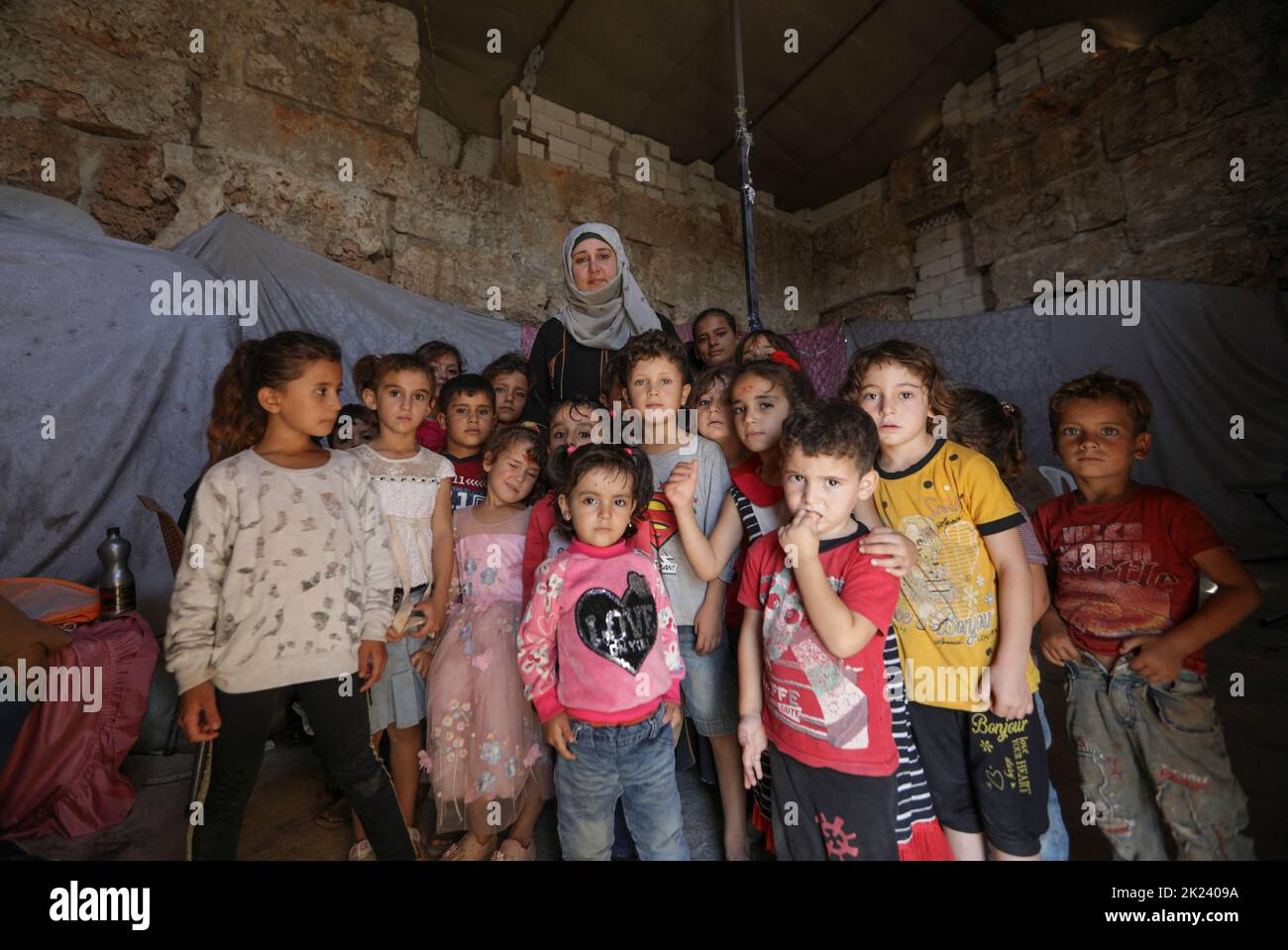 Najlaa Mimar, a history graduate who has transformed a Byzantine castle into a school for the internally displaced children, poses for a picture with students, in the opposition-held Idlib, Syria September 20, 2022. REUTERS/Khalil Ashawi Stock Photo