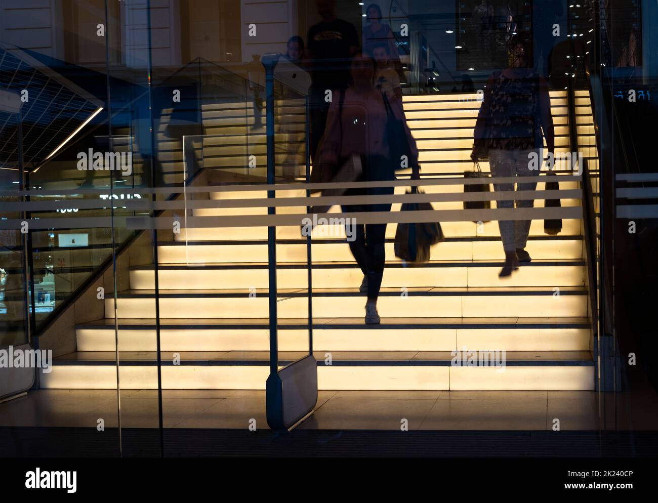Madrid, Spain, September 2022.  people walking down the illuminated stairs of a shop in the city center Stock Photo