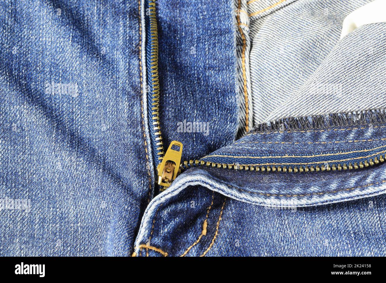 The open zipper of blue denim jeans open, Closeup view of blue jeans with zipper. Stock Photo