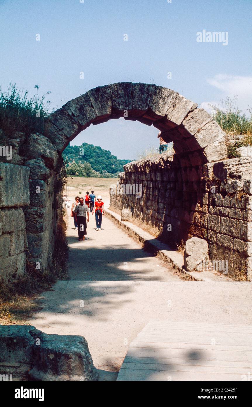Stadium entrance (vaulted tunnel) at Olympia - a small town in Elis on the Peloponnese peninsula in Greece, famous for the nearby archaeological site of the same name. This site was a major Panhellenic religious sanctuary of ancient Greece, where the ancient Olympic Games were held every four years throughout Classical antiquity, from the 8th century BC to the 4th century AD. April 1980. Archival scan from a slide. Stock Photo