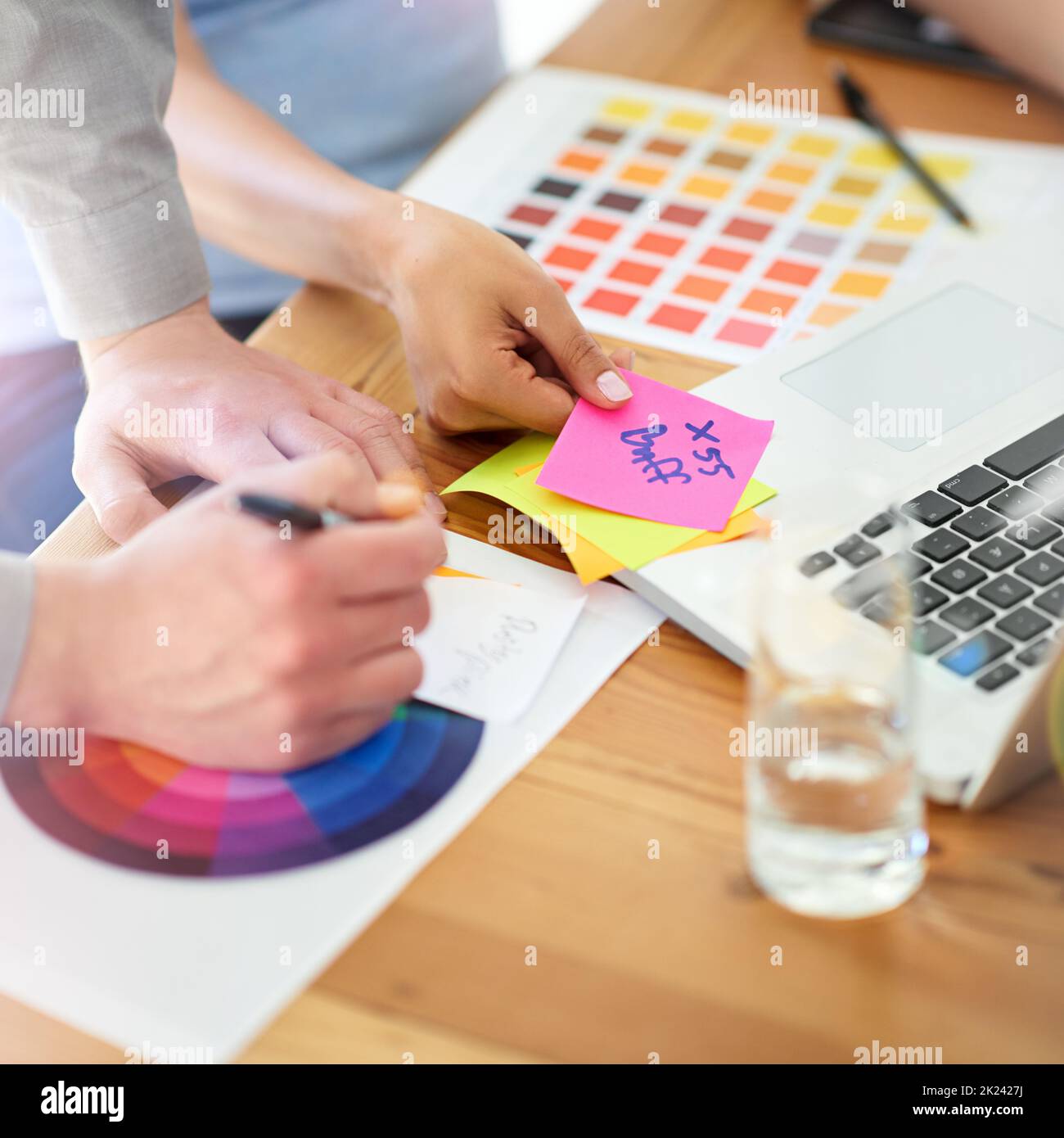Getting creative with color. two unrecognizable designers working with color swatches in their office. Stock Photo