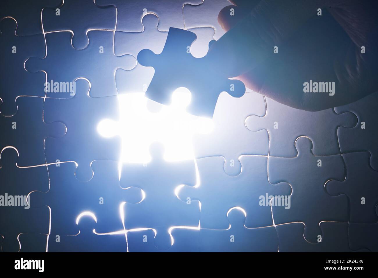Completing the puzzle. a puzzle missing a single piece Stock Photo - Alamy