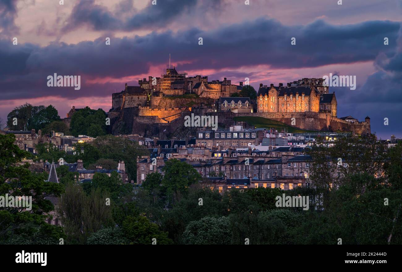 The capital city's skyline with lit up landmark Edinburgh Castle on rocky outcrop at twilight, Edinburgh, Scotland, UK Stock Photo