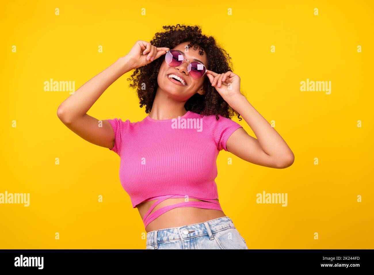 Photo of cool brunette lady wear glasses pink t-shirt isolated on vibrant orange color background Stock Photo