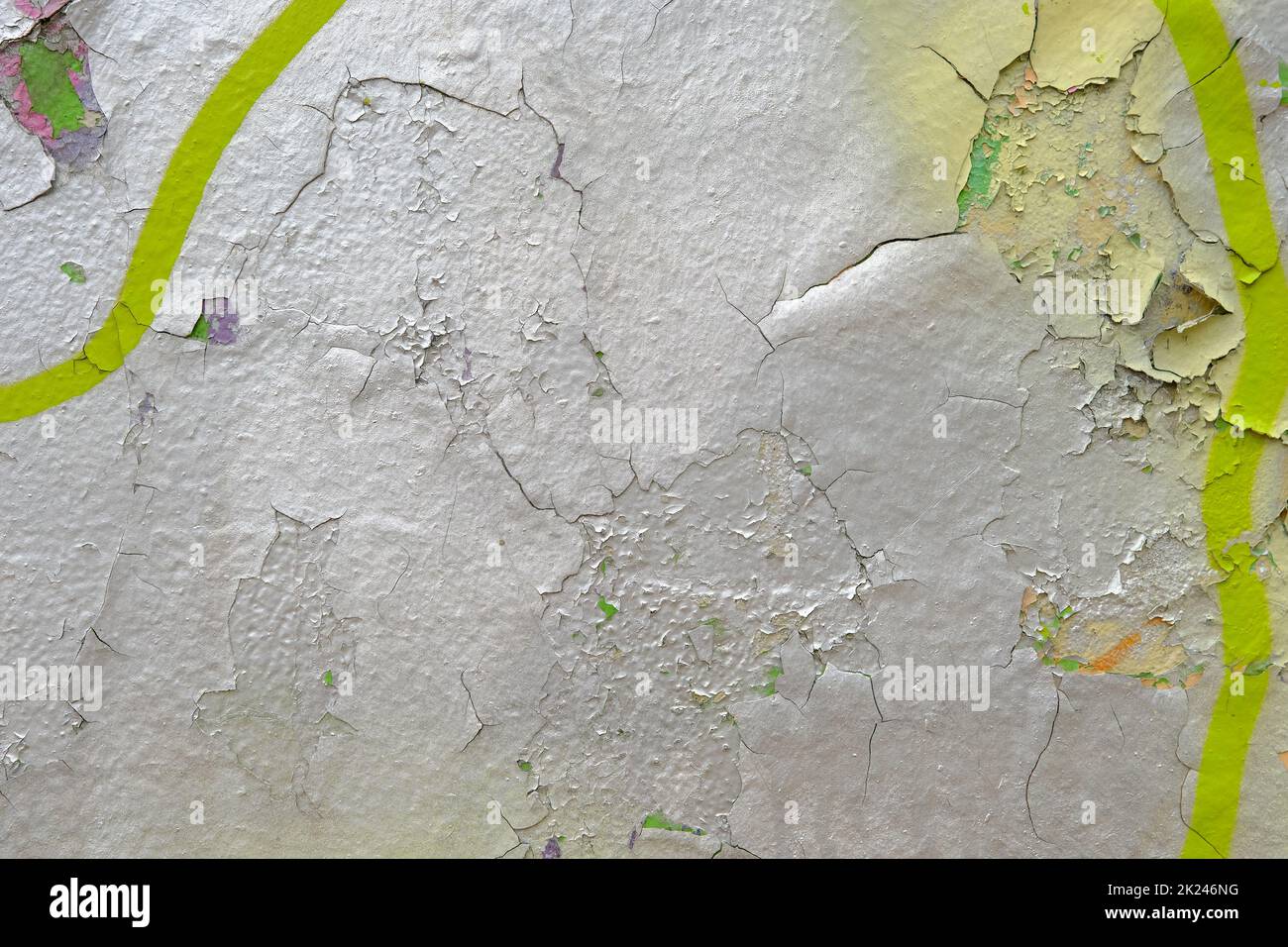 Colorful wall background with damaged paints of gray silver and yellow. Stock Photo