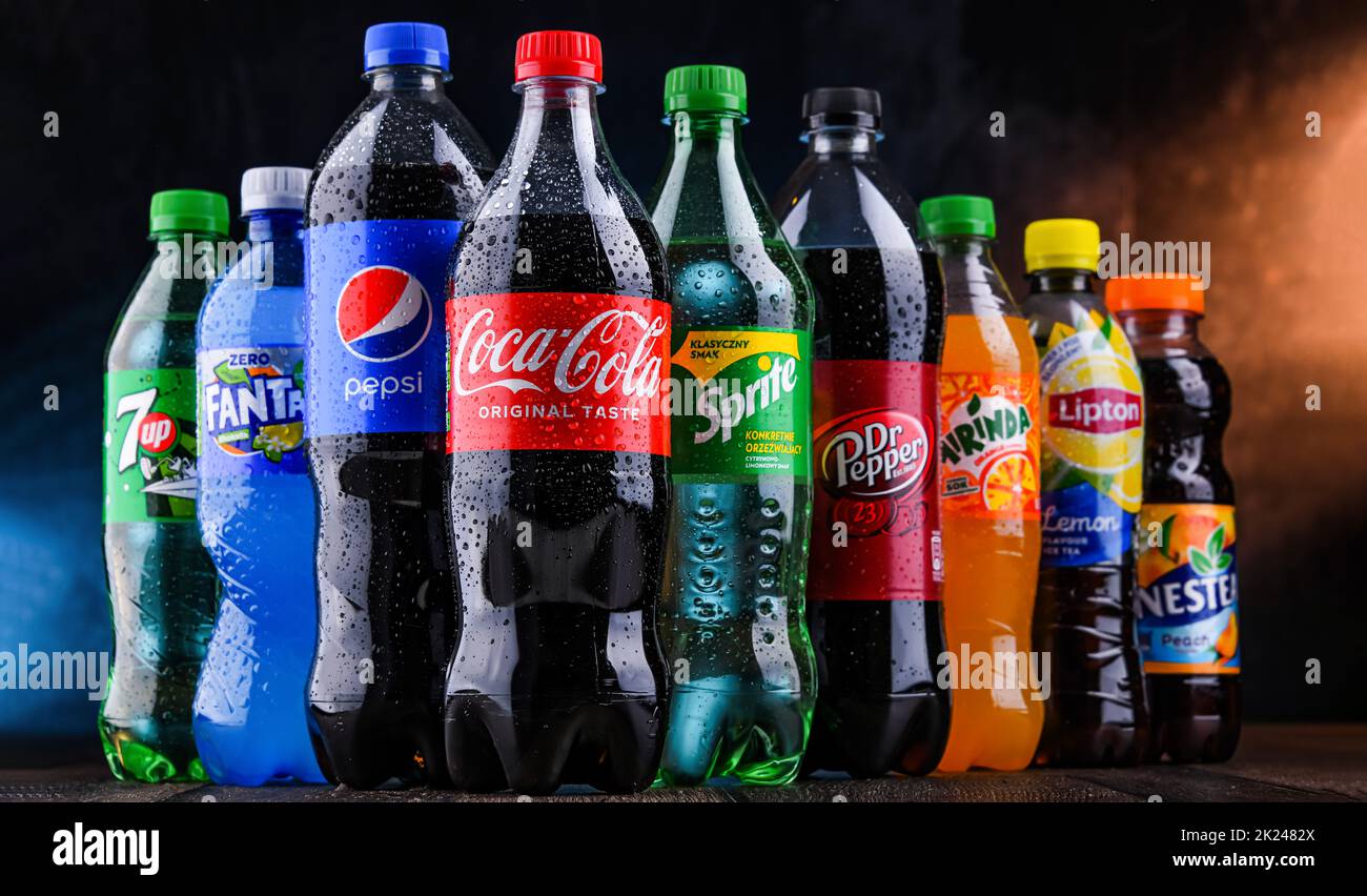 POZNAN, POLAND - OCT 28, 2021: Bottles of global soft drink brands including products of Coca Cola Company and Pepsico Stock Photo
