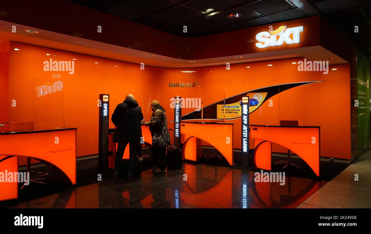 Dortmund, Germany - December 28, 2021: Sixt car rental employee waits for customers at Dortmund Airport 21 in Germany. Sixt has some 4,000 locations i Stock Photo