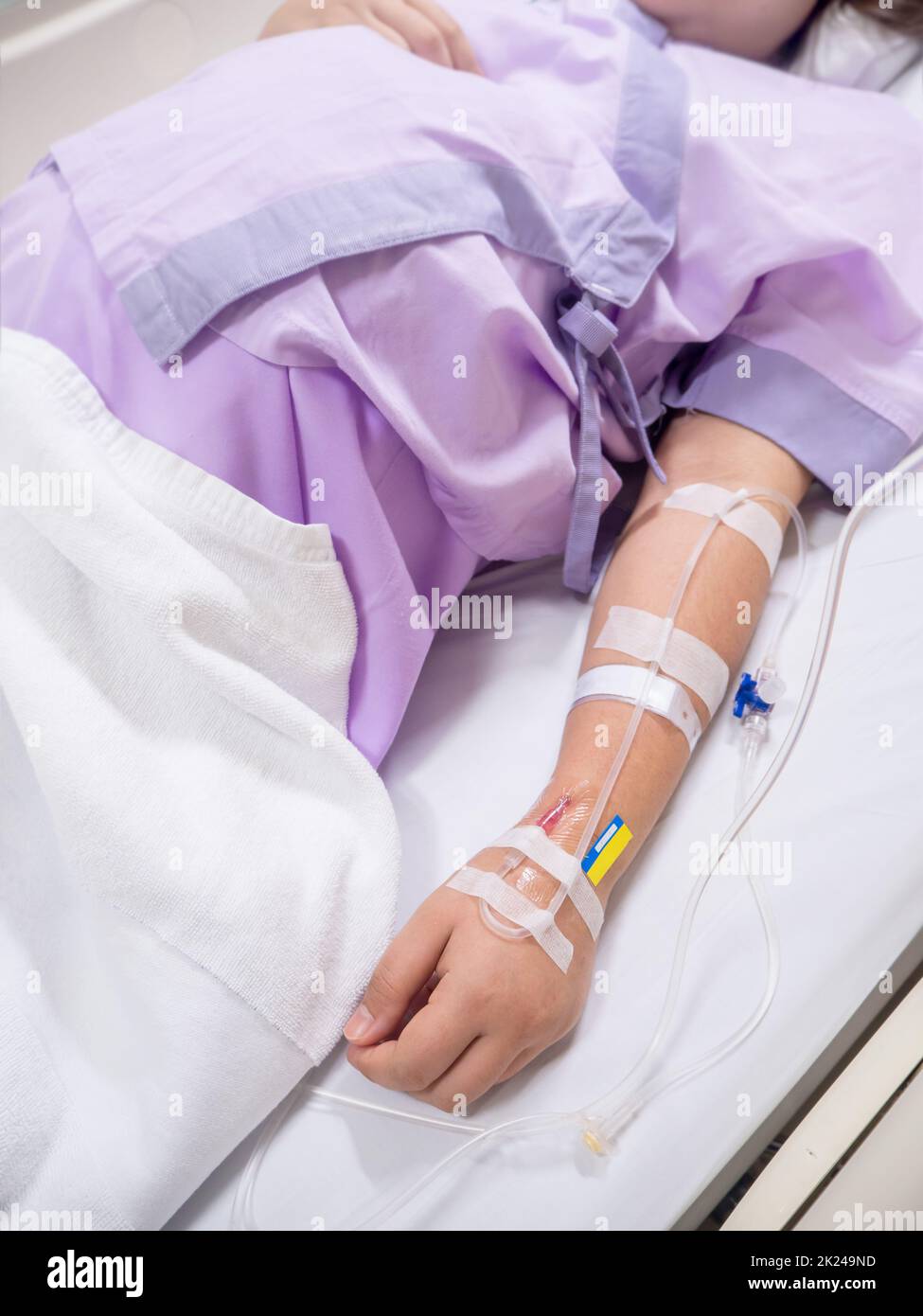 close up of saline solution on hand of women patient in pink clothes