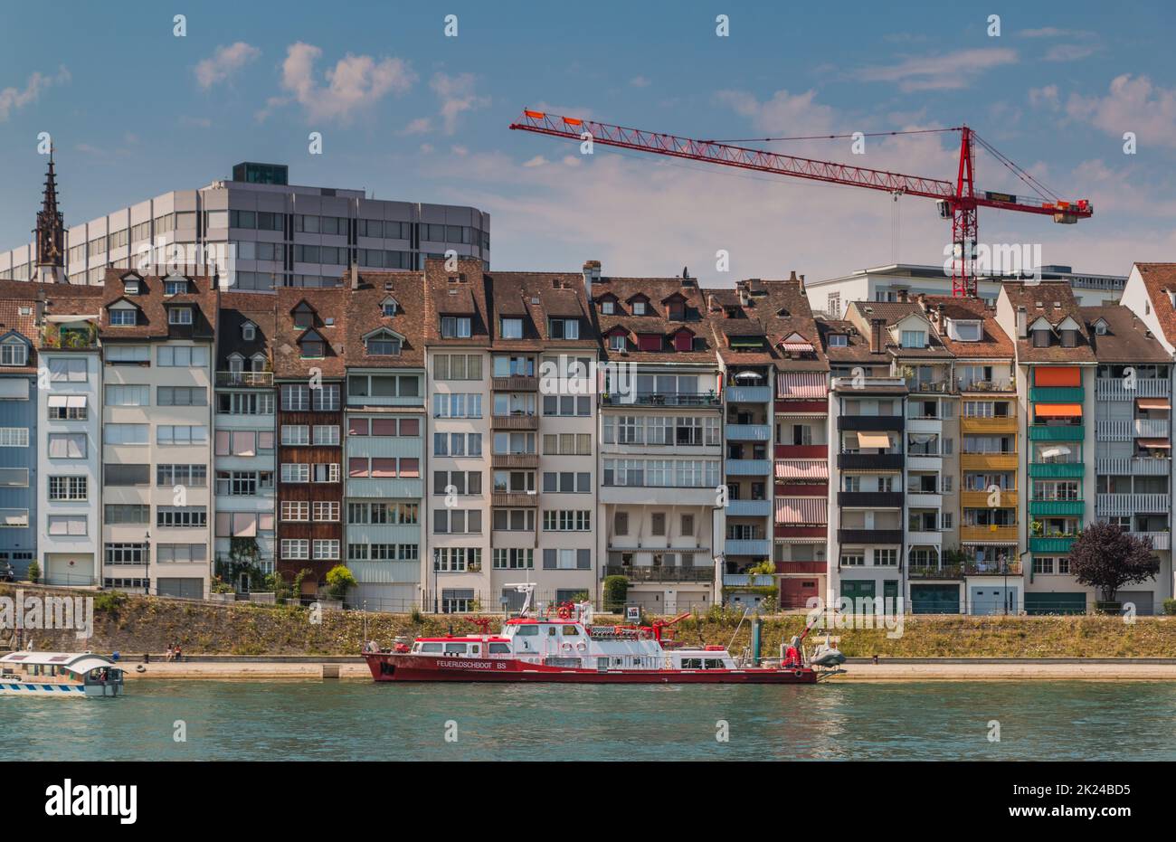 A picture of a row of narrow apartment buildings on the riverside of ...