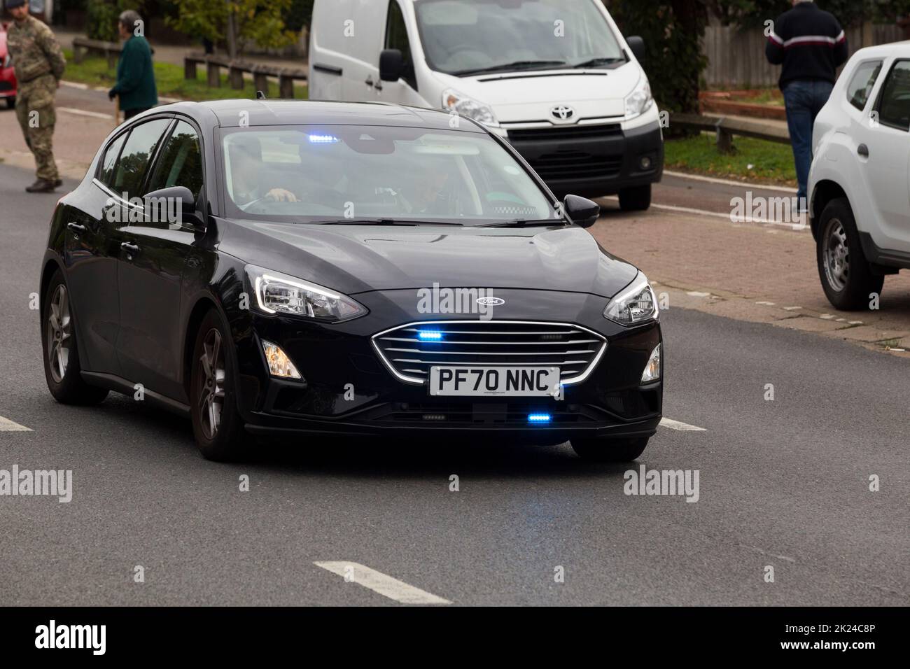 Unmarked police car made by the Ford motor company with its blue lights on and travelling at speed. The numberplate of the vehicle has been digitally altered and does not show the real registration. (132) Stock Photo