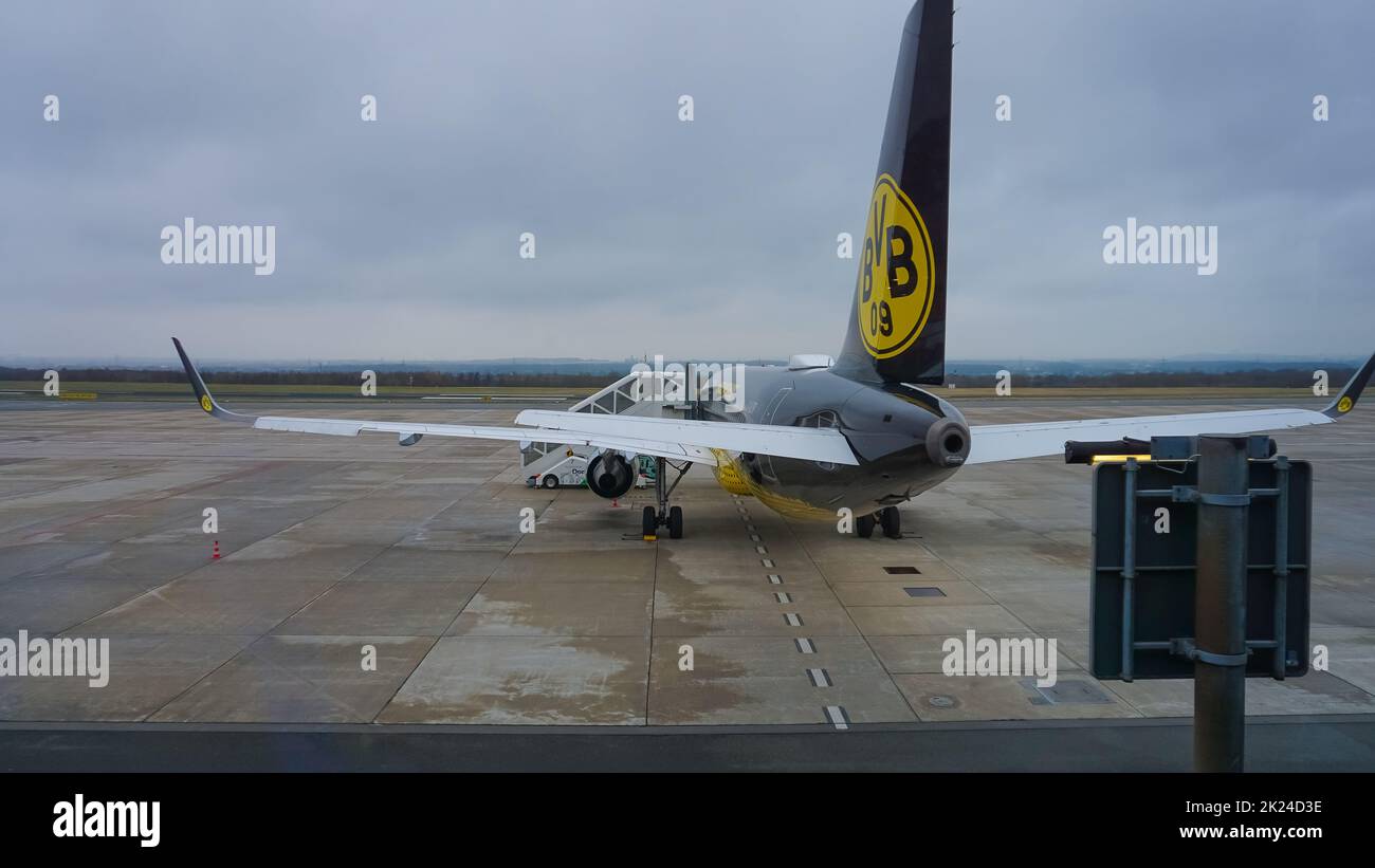 Dortmund, Germany - January 04, 2022: Black and yellow airplane with logo of the german football club Borussia Dortmund BVB Stock Photo
