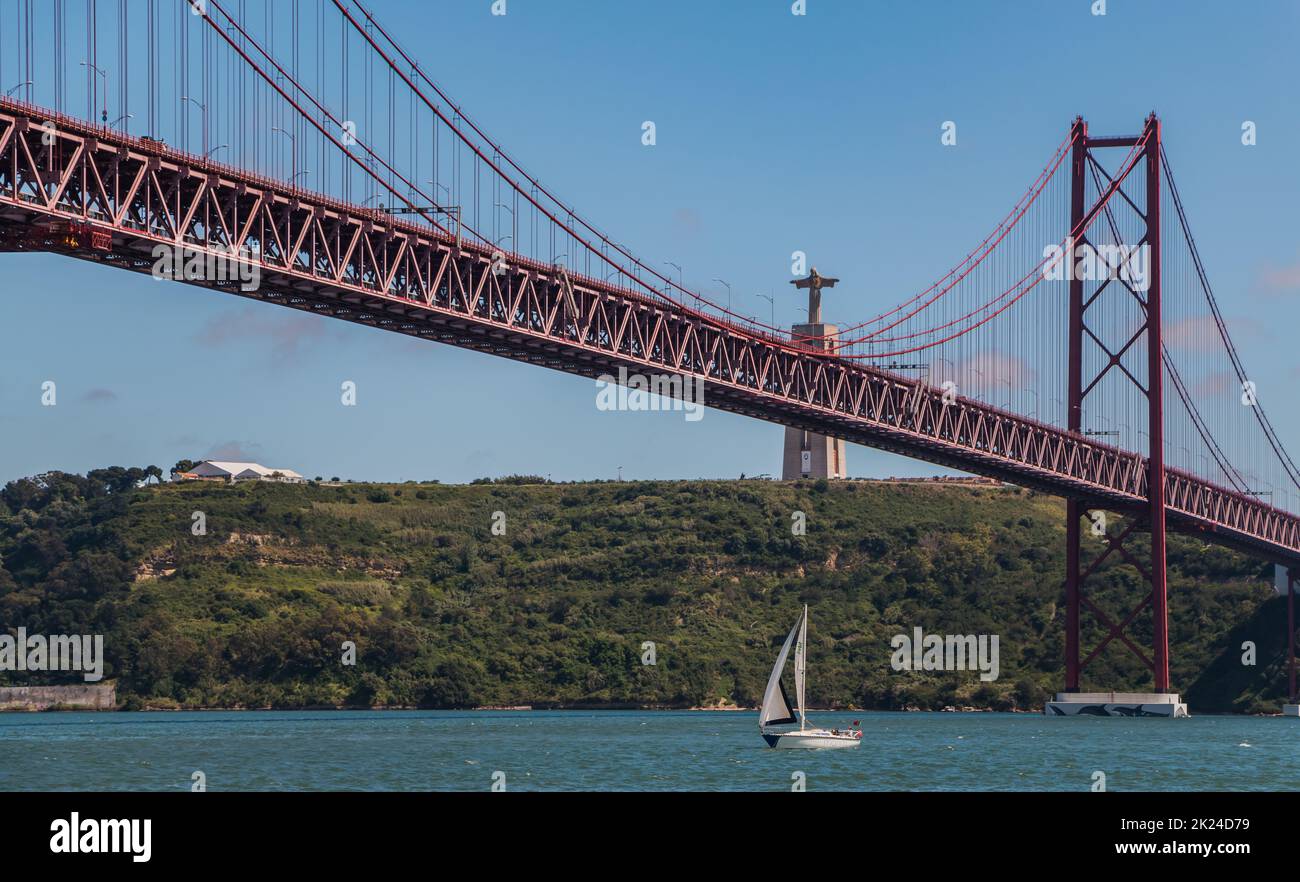 A picture of the Tejo River featuring the Cristo Rei statue and the 25 ...