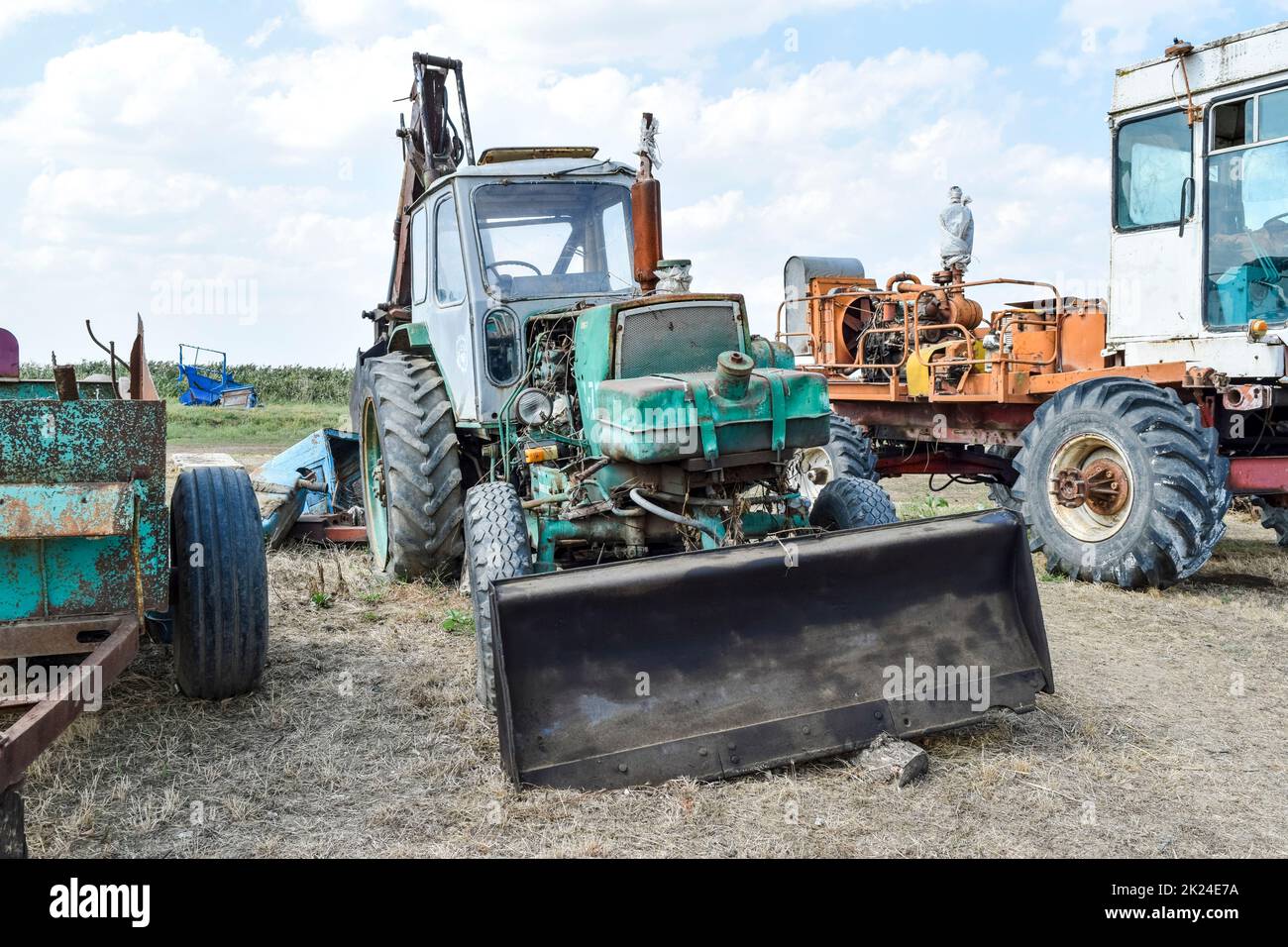 Russia, Temryuk - 15 July 2015: Tractor. Bulldozer and grader. Tractor with a bucket for digging soil. The picture was taken at a parking lot of tract Stock Photo