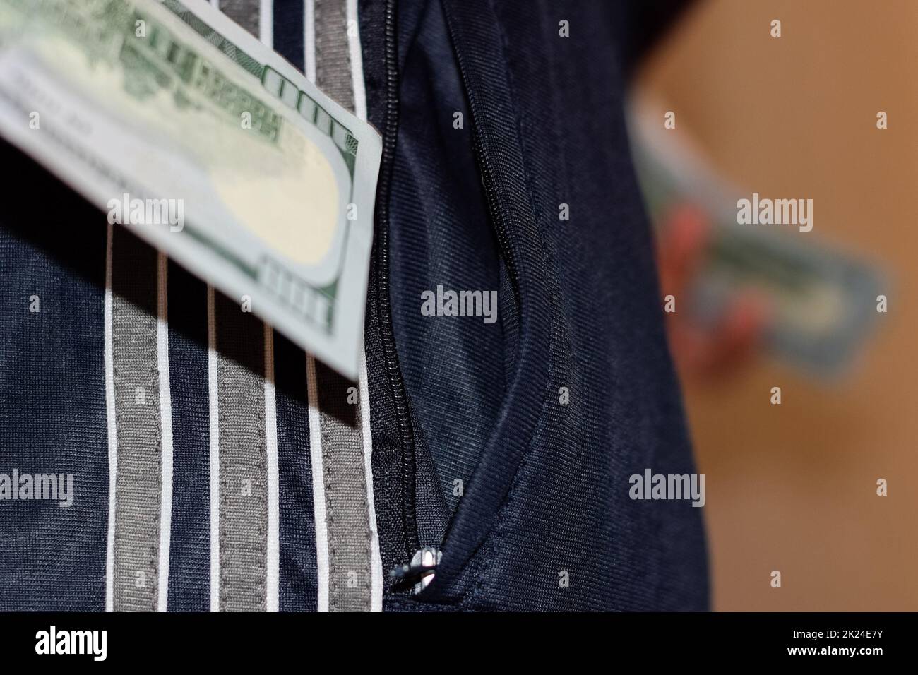 A wad of money in the pocket of a man's pants. Dollars in your pocket. Stock Photo