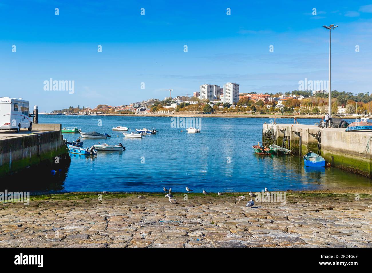Porto, Portugal - October 23, 2020: Small fishing boats in the fishing port of Afurada at the exit of the mouth of the Douro river on an autumn day Stock Photo