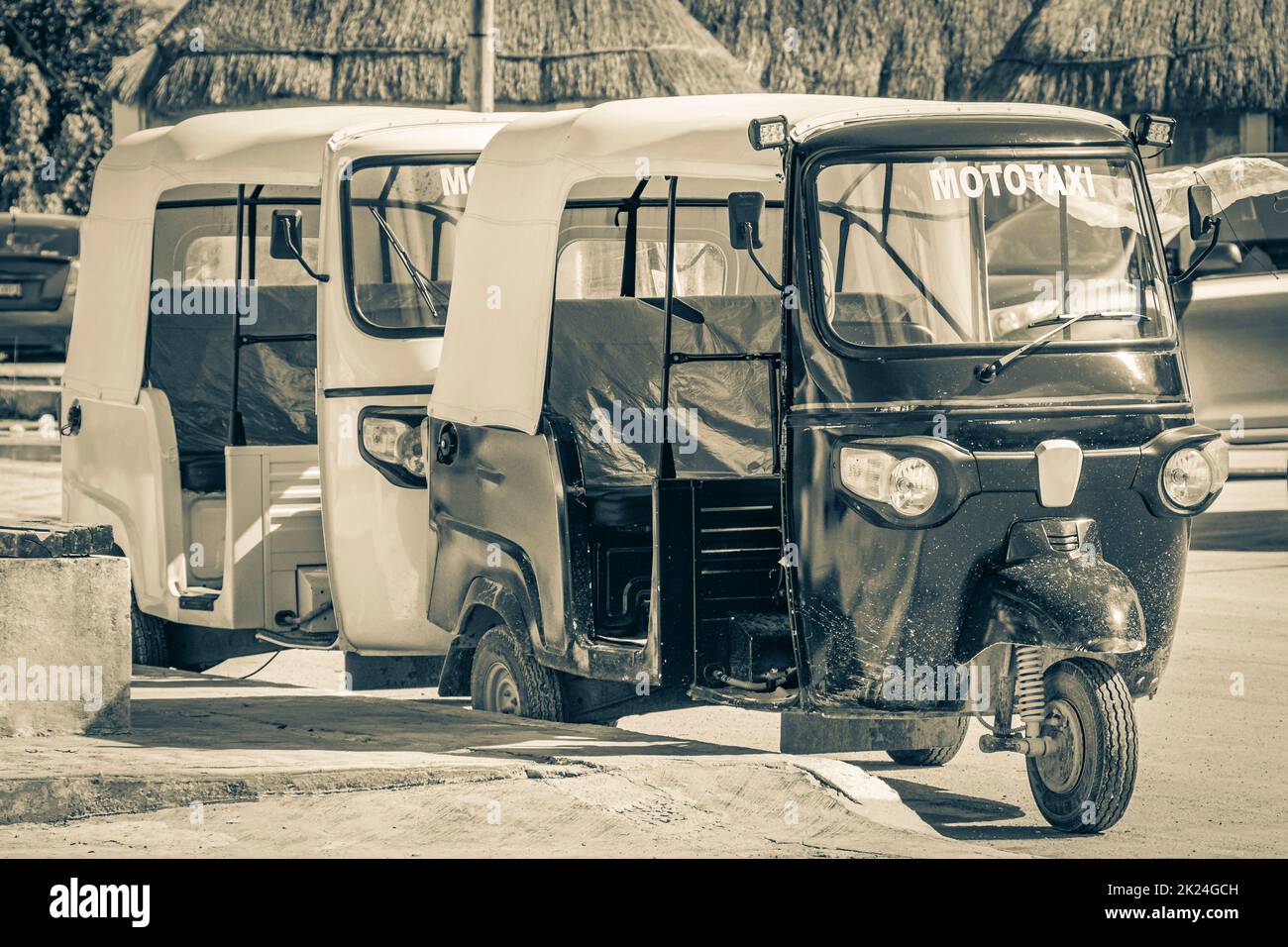 Black and white picture of auto rickshaw tuk tuk in beautiful Chiquilá village port harbor Puerto de Chiquilá in Quintana Roo Mexico. Stock Photo