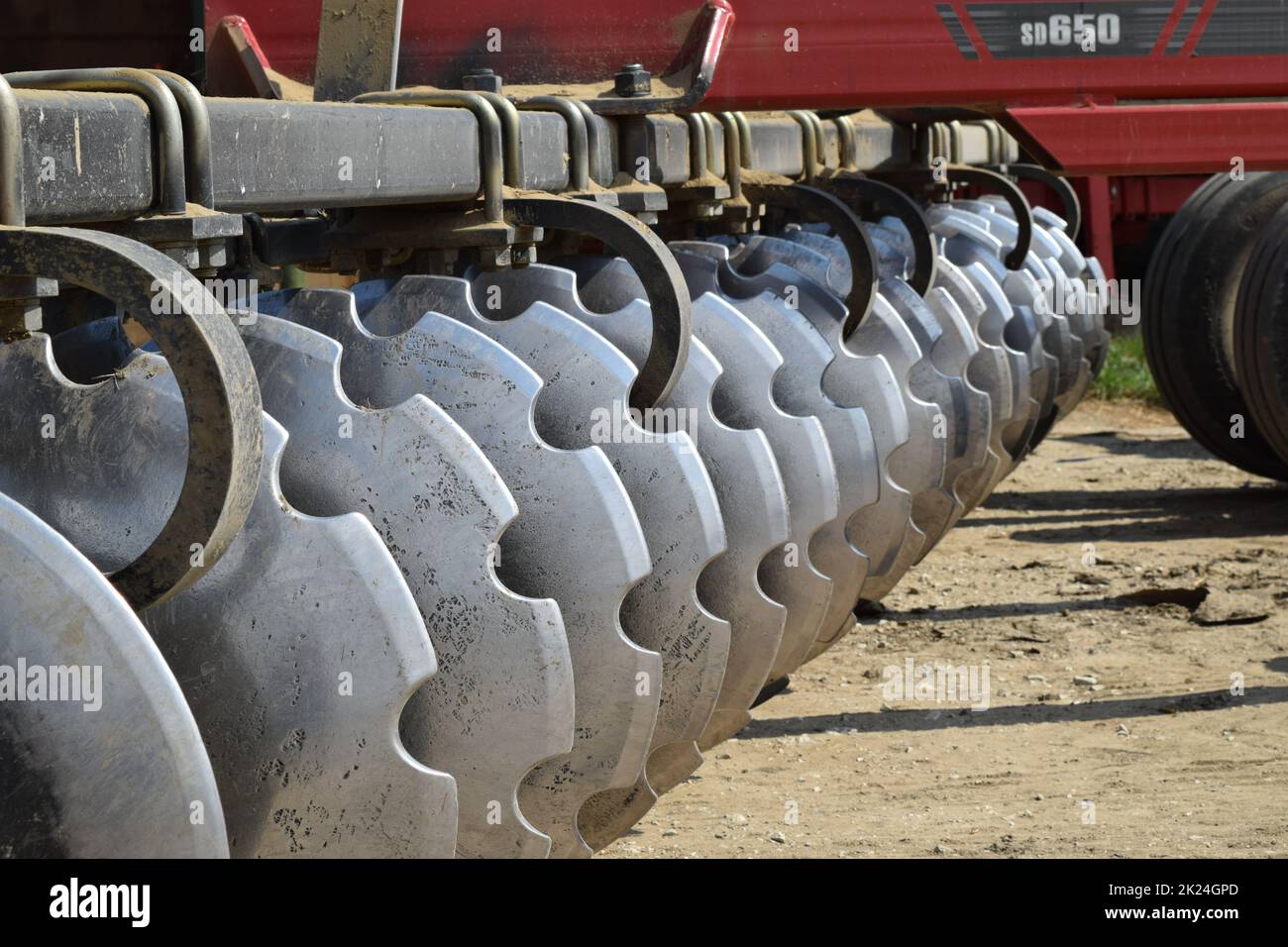 The disk harrow. Agricultural machinery for processing of the soil in the field. Stock Photo