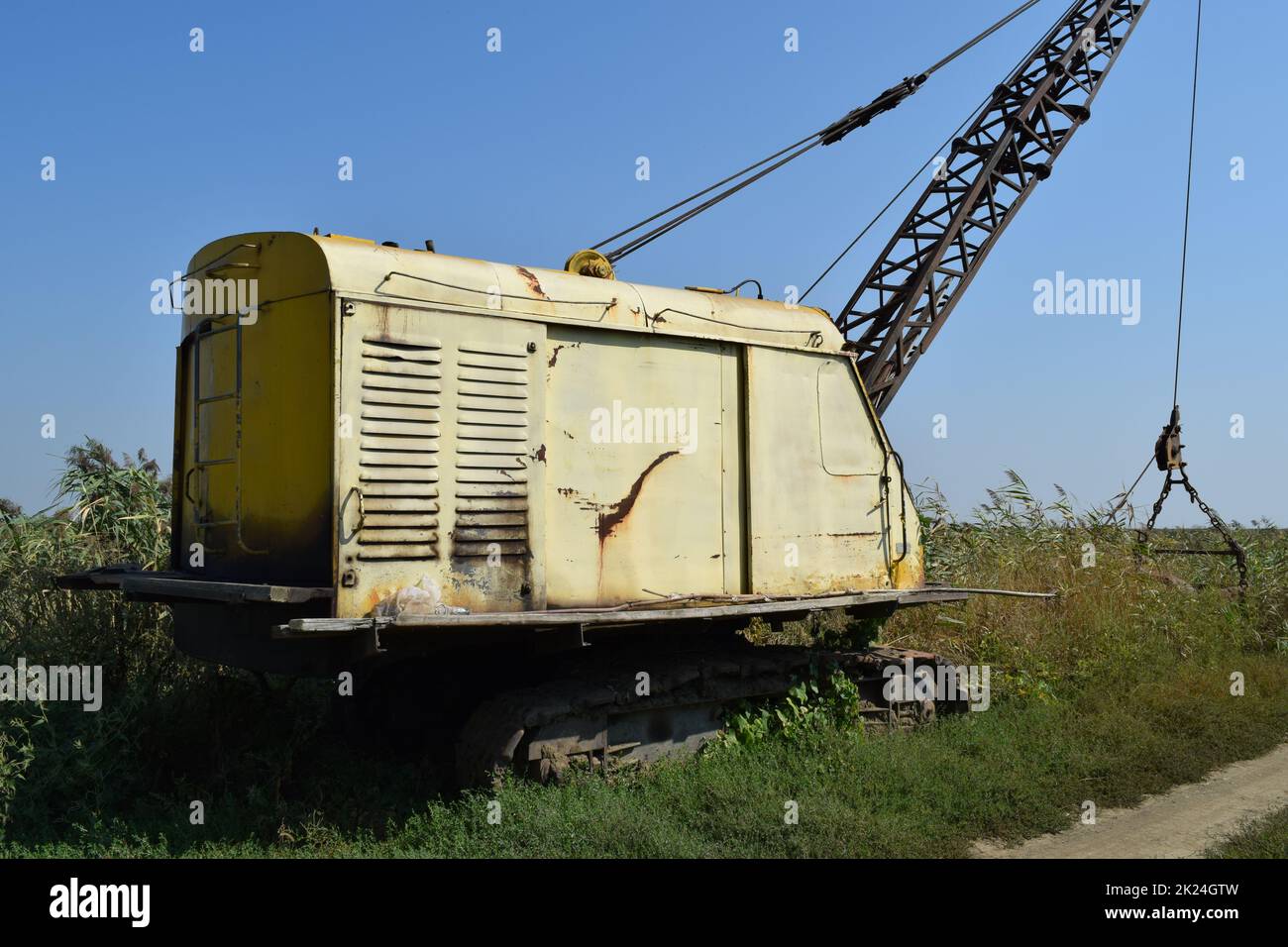 Old quarry near the dragline. Old equipment for digging the soil in canals and quarries. Stock Photo
