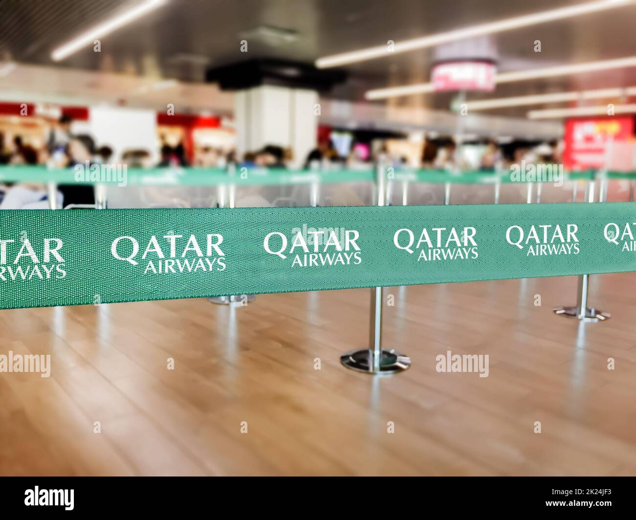 Doha, Qatar, July 2021: Green belt barrier with the Qatar Airways logo. Qatar Airways is the flag carrier airline of Qatar. Travel and airport securit Stock Photo