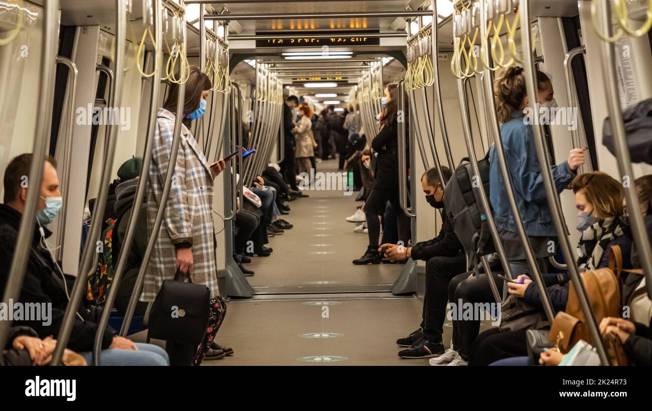 BUCHAREST, ROMANIA - May 15, 2021: Subway during Coronavirus crisis. People wearing masks at train interior during covid-19, spring 2021, People on th Stock Photo