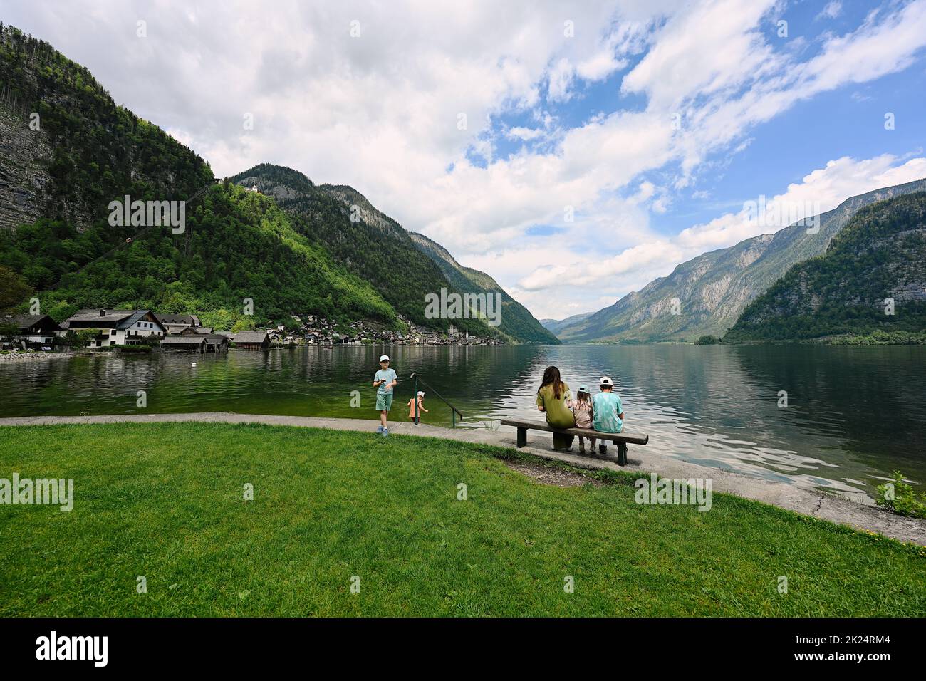 Mother with four children over Austrian alps lake in Hallstatt, Salzkammergut, Austria. Stock Photo