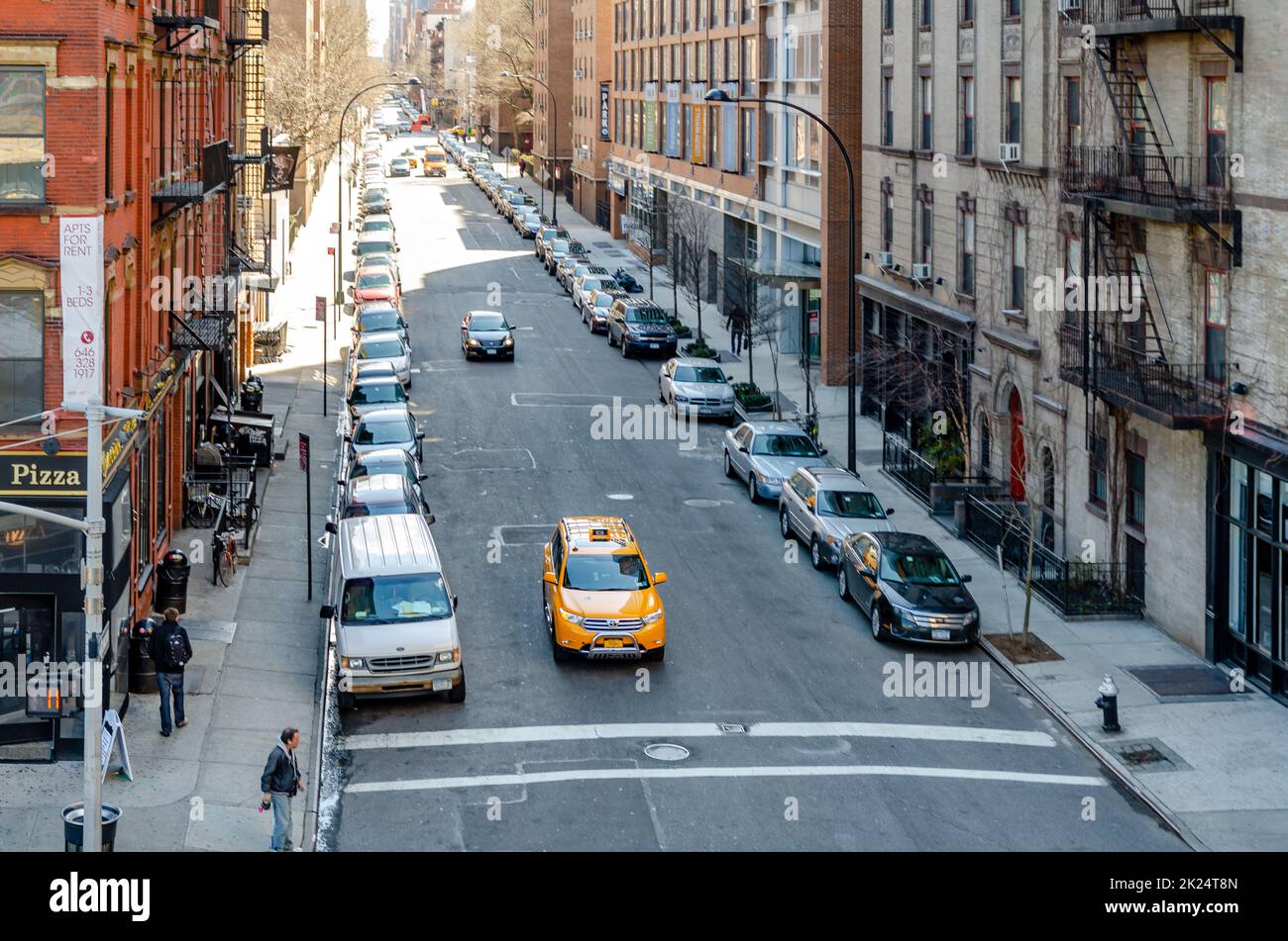 City street in Chelsea with yellow taxi cab in the front, people ...