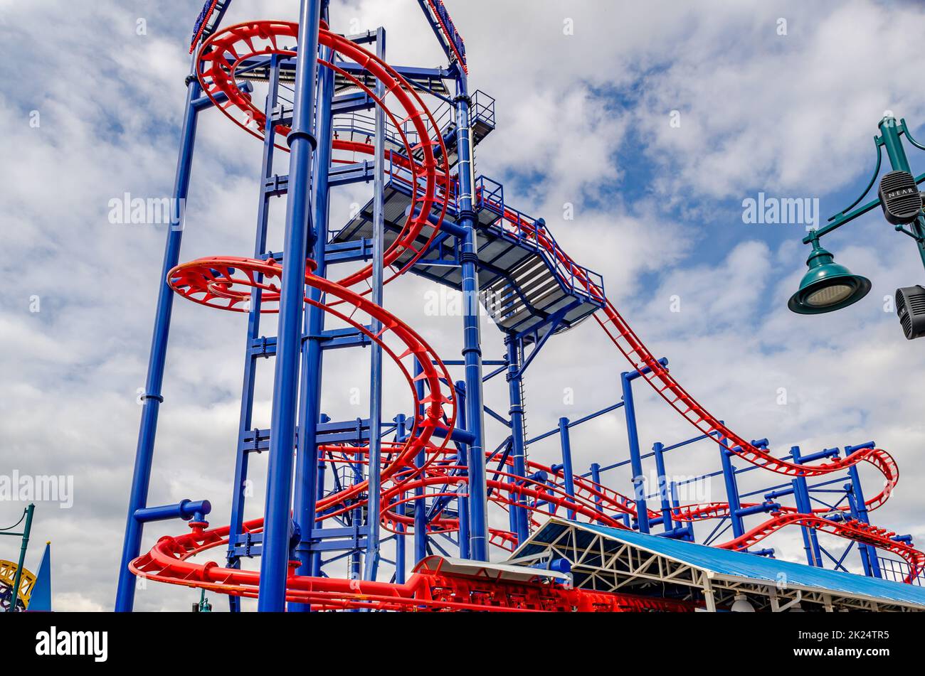 Soarin' Eagle Red Rollercoaster at Coney island, Brooklyn, New York City during winter day with cloudy sky, view from low angle, horizontal Stock Photo