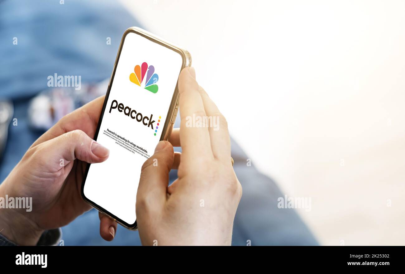 New York, USA, September 2021: woman launching the Peacock Tv mobile app on her smart phone. Peacock is an American video streaming service Stock Photo