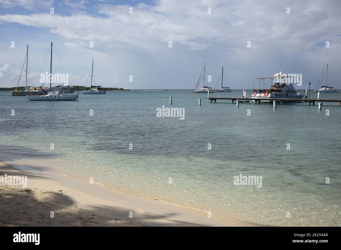 ORANJESTAD, ARUBA - DECEMBER 4, 2021: Local and cruising catamarans and local motorboats anchoring at Surfside Beach in Oranjestad on the Caribbean is Stock Photo