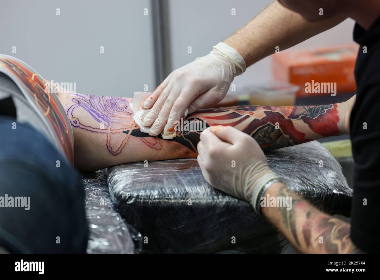 Krakow, Poland -  June 11, 2022: 15th Tattoofest in Cracow. One of the most prestigious tattoo festivals. Tattoo artist at work. The process of tattoo Stock Photo