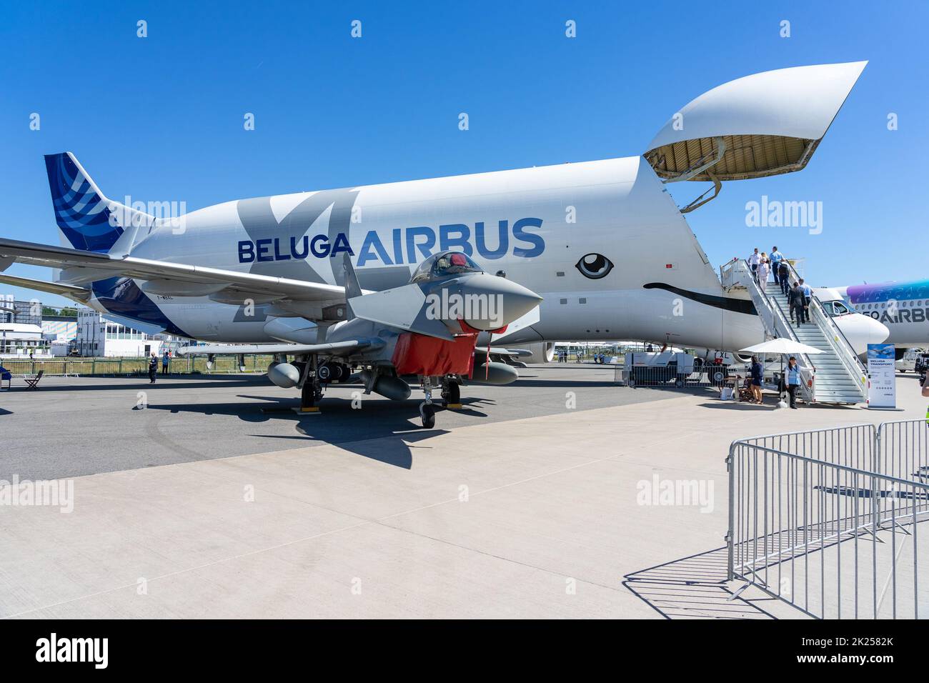 BERLIN, GERMANY - JUNE 23, 2022: Twin-engine, canard delta wing, multirole fighter Eurofighter Typhoon against the backdrop of an Airbus A300-600ST Be Stock Photo