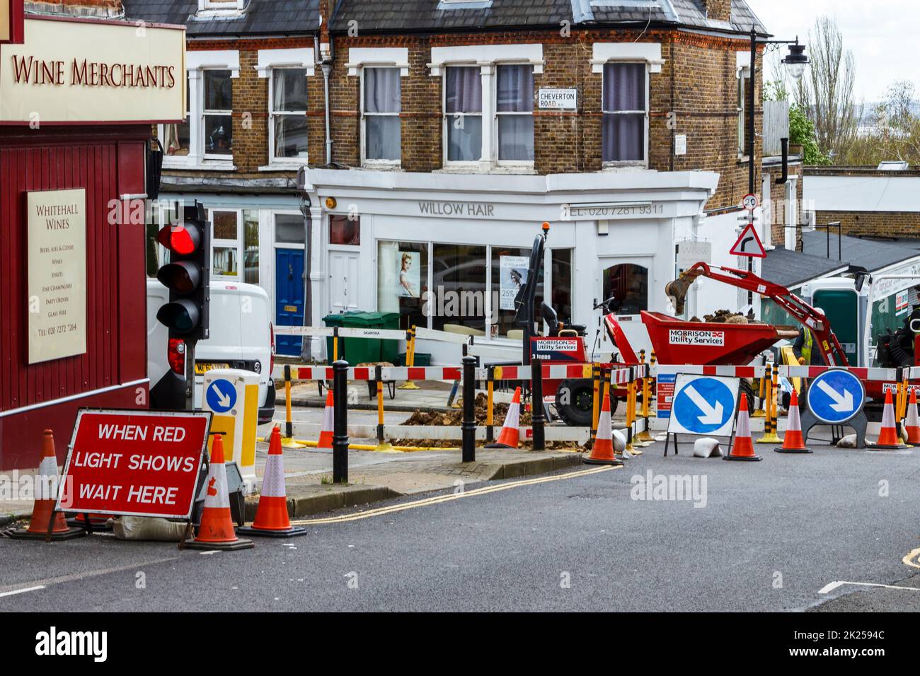 Red and white warning markers, cones and fencing, footpath closed for repairs in Islington, North London, UK Stock Photo