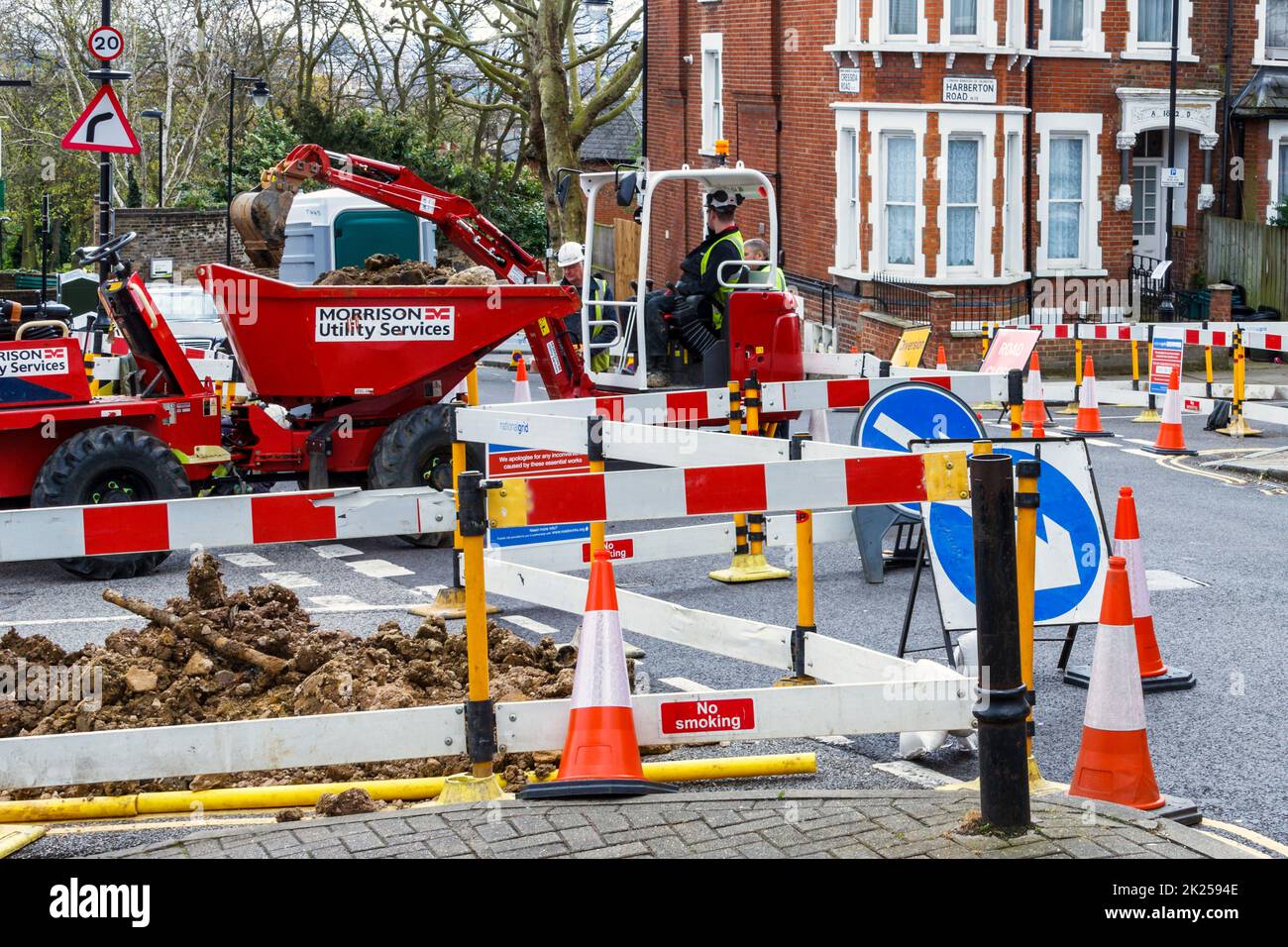 Red and white warning markers, cones and fencing, footpath closed for repairs in Islington, North London, UK Stock Photo