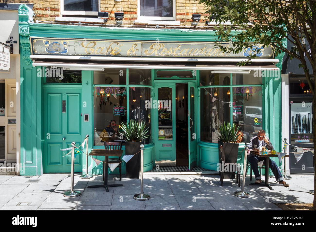 A diner seated outside a restaurant in Navigator square in Archway