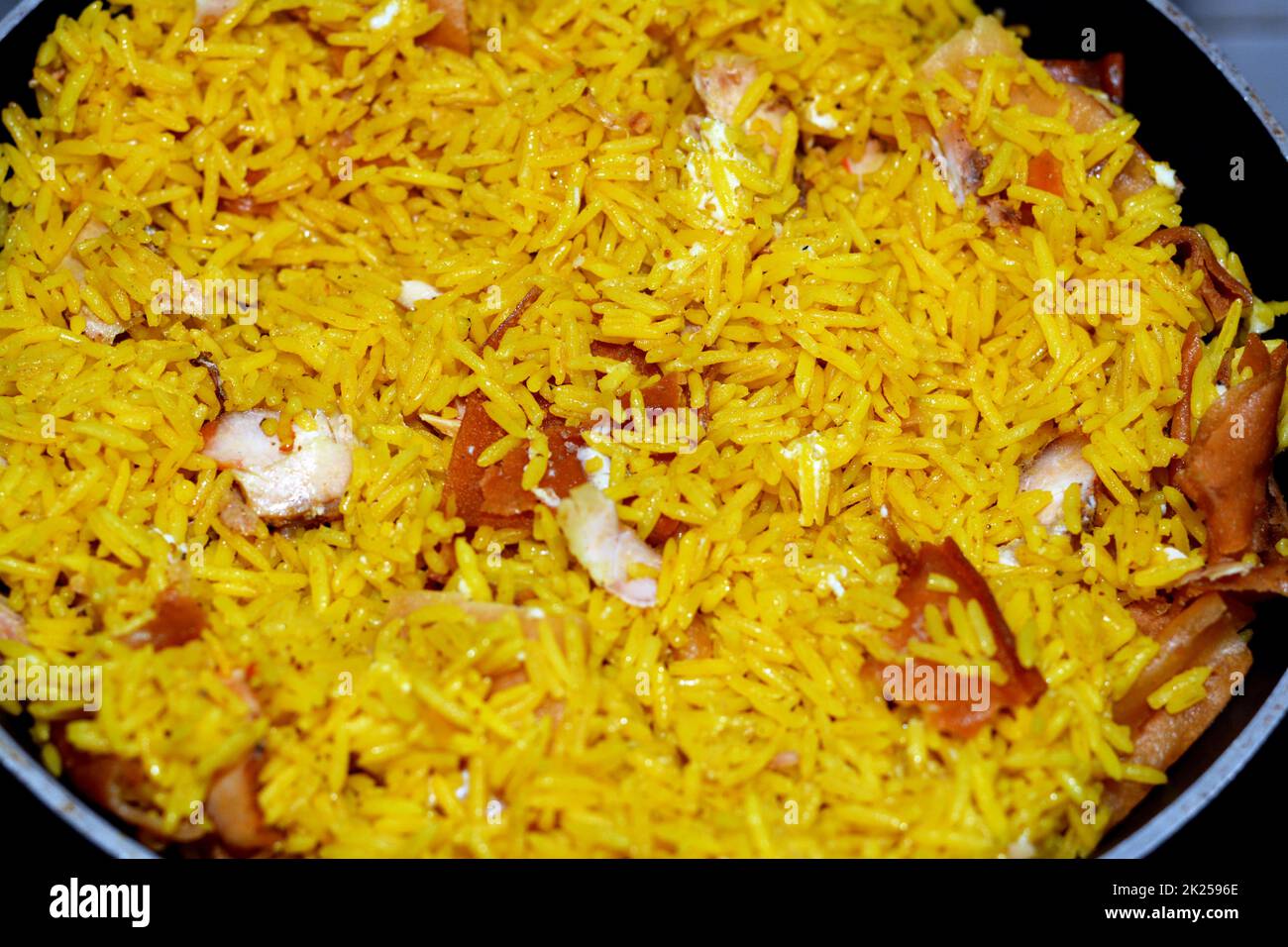 Pieces of Chicken shawarma with yellow Basmati rice, Syrian bread and